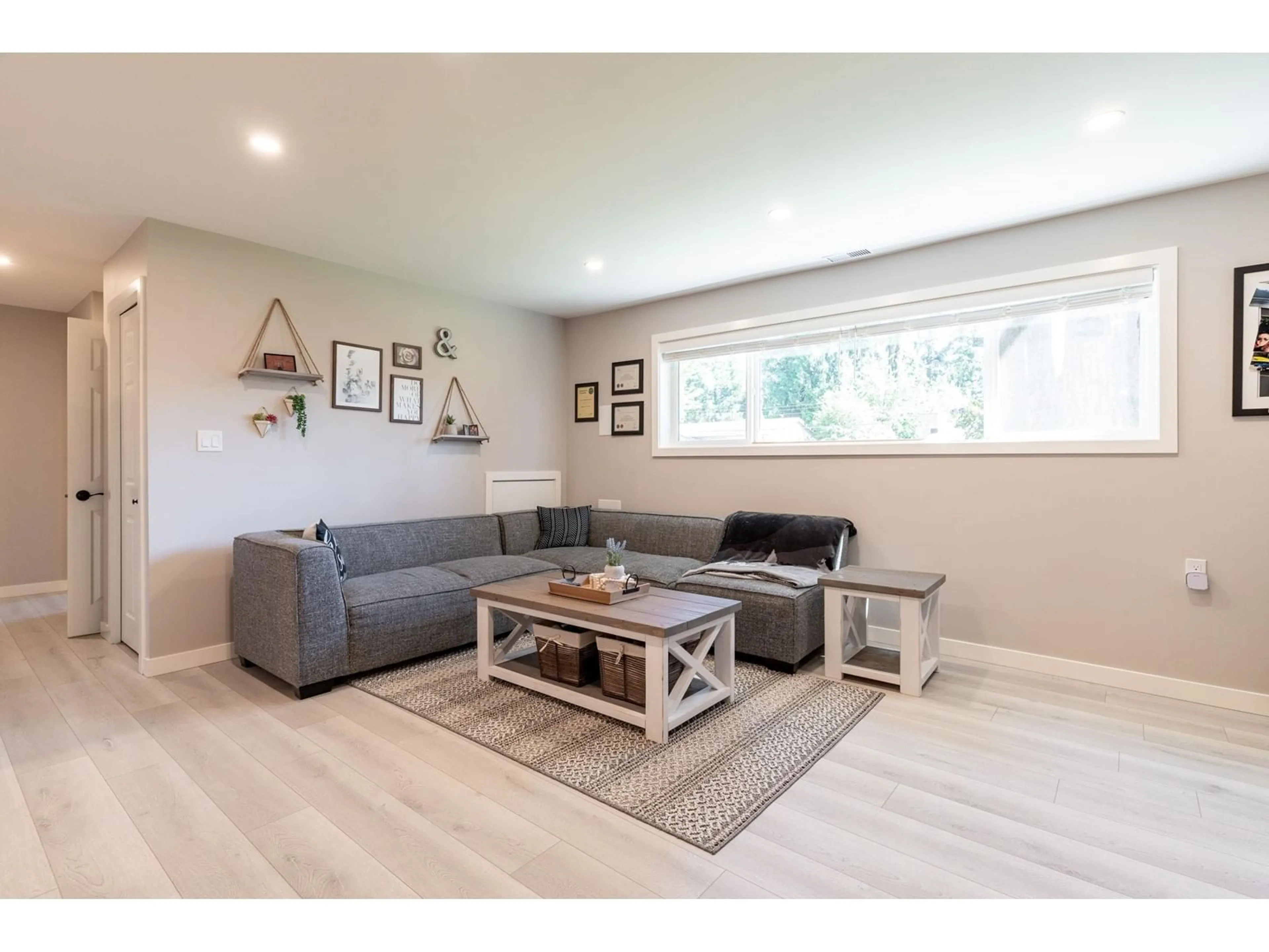 Living room with furniture, wood/laminate floor for 25165 11B AVENUE, Langley British Columbia V4W2S7