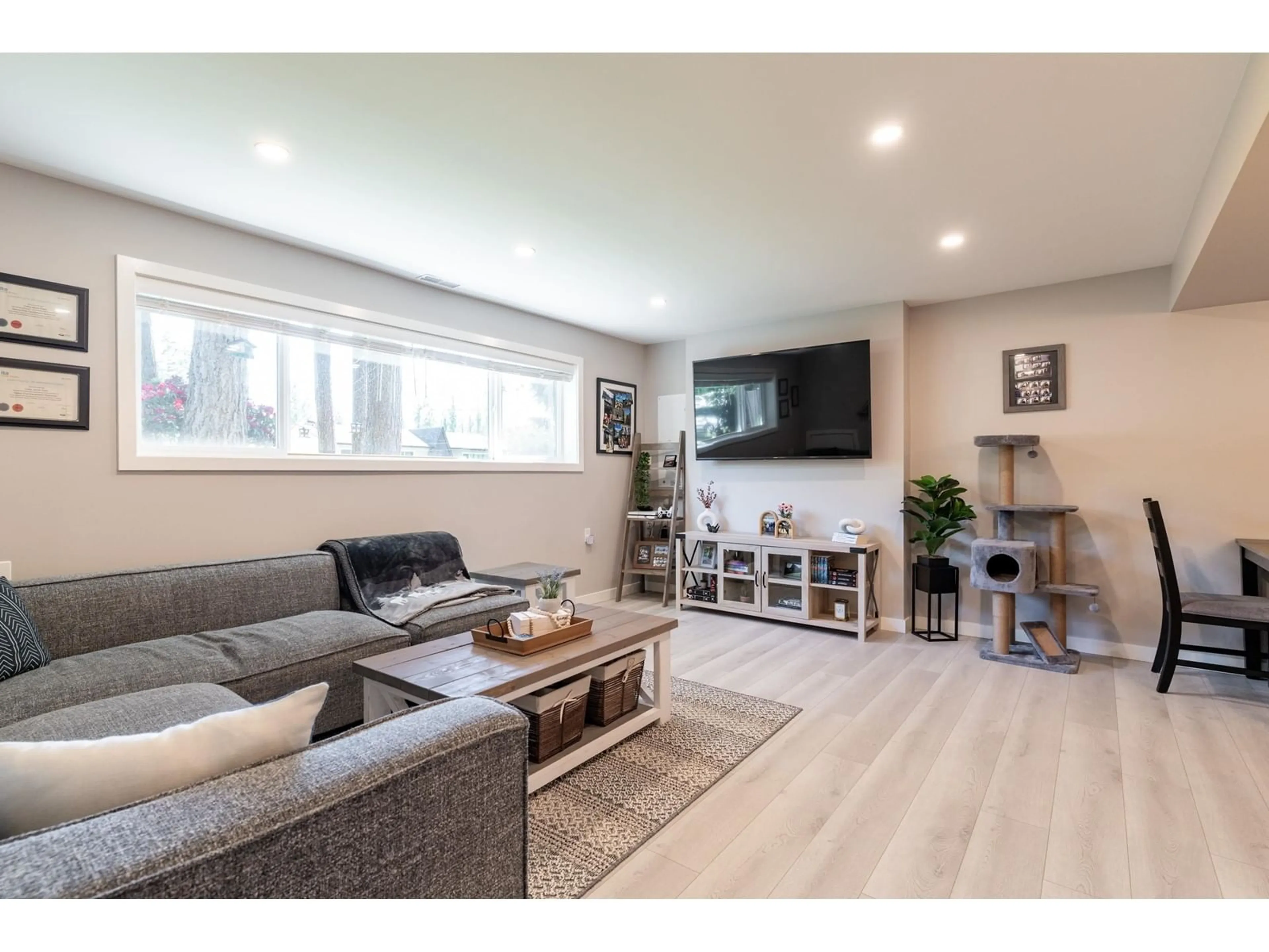 Living room with furniture, wood/laminate floor for 25165 11B AVENUE, Langley British Columbia V4W2S7