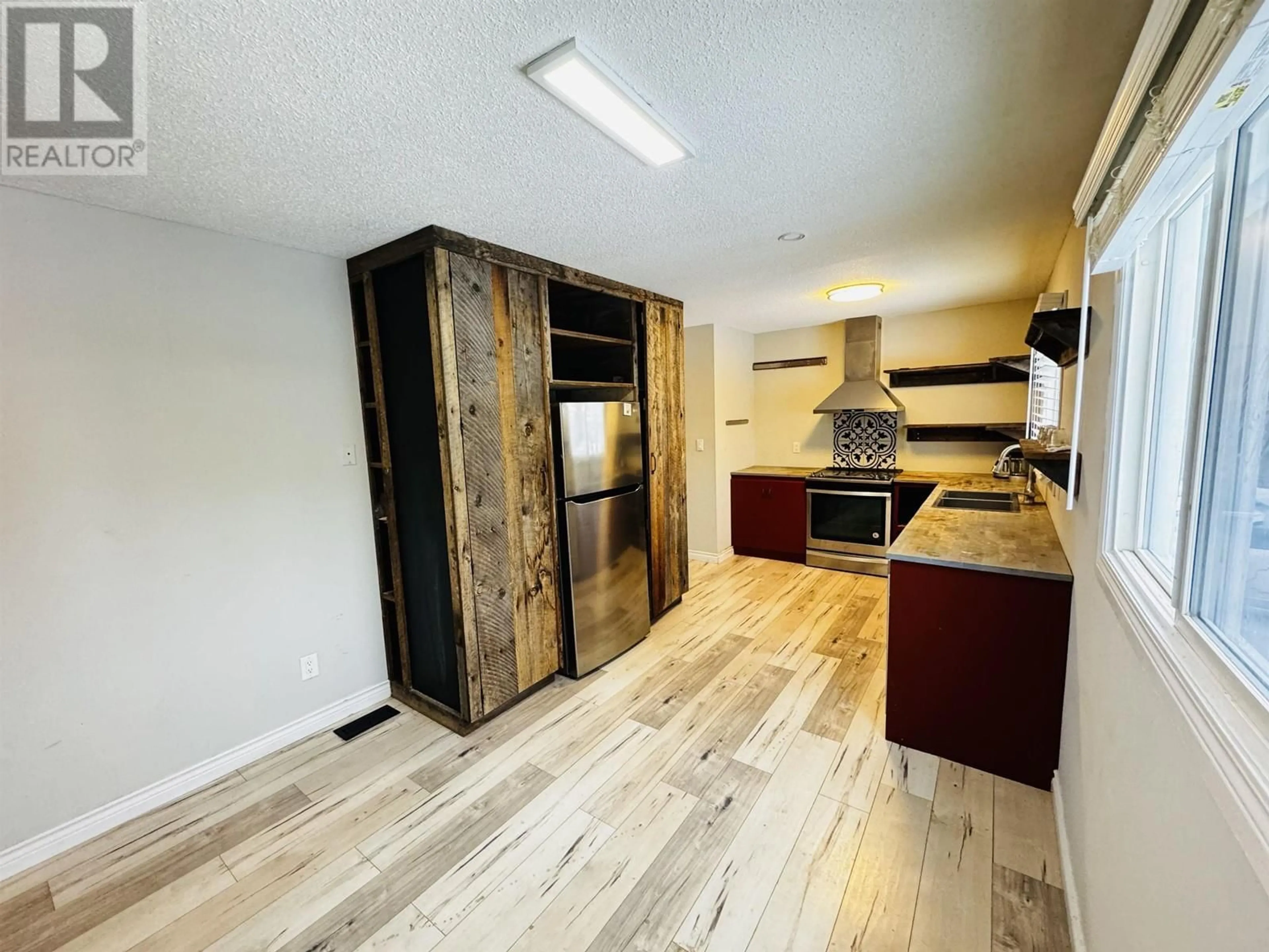 Open concept kitchen, wood/laminate floor for 976 QUESNEL AVENUE, Prince George British Columbia V2M4B6