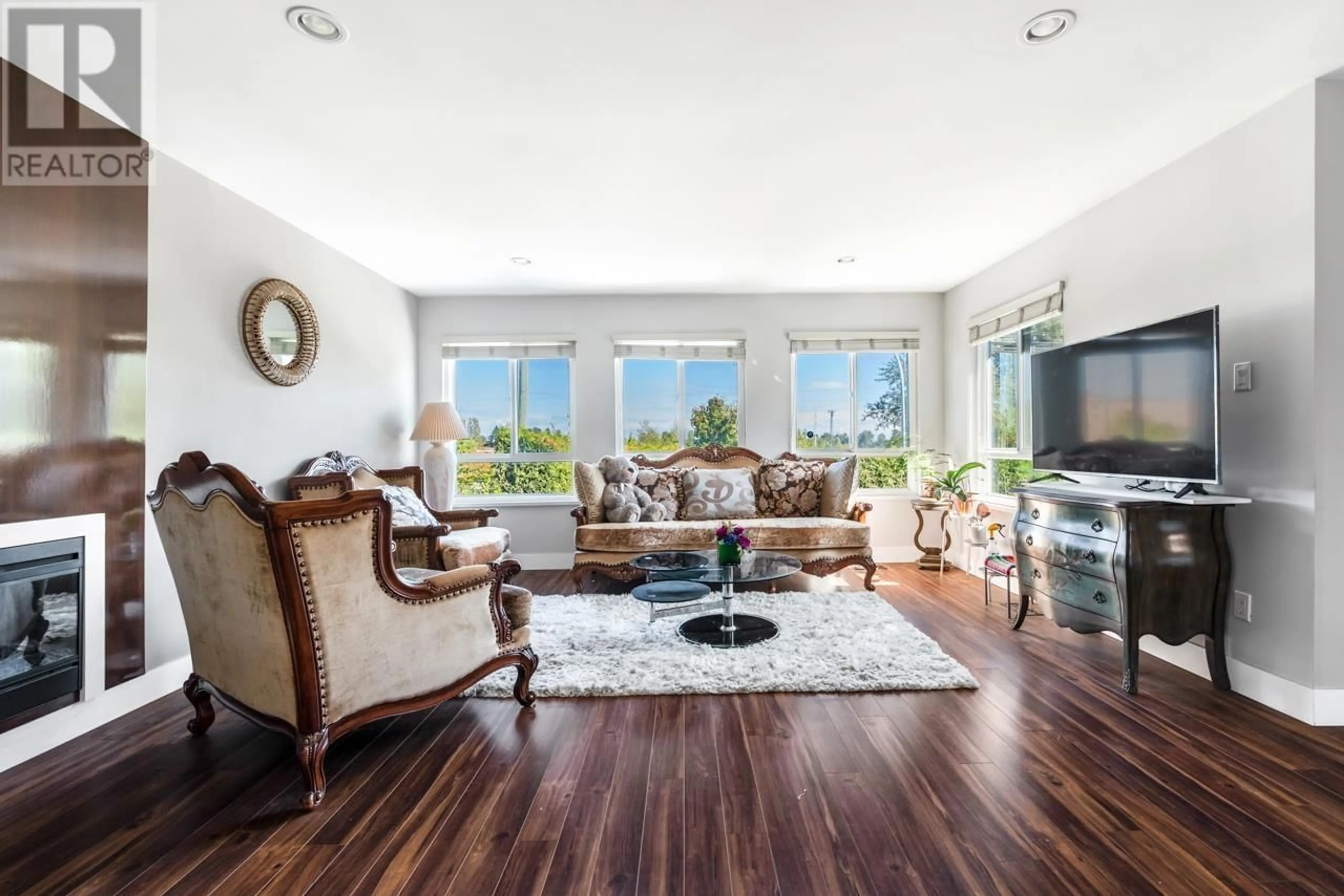 Living room with furniture, wood/laminate floor for 8711 NO. 5 ROAD, Richmond British Columbia V6Y2V5