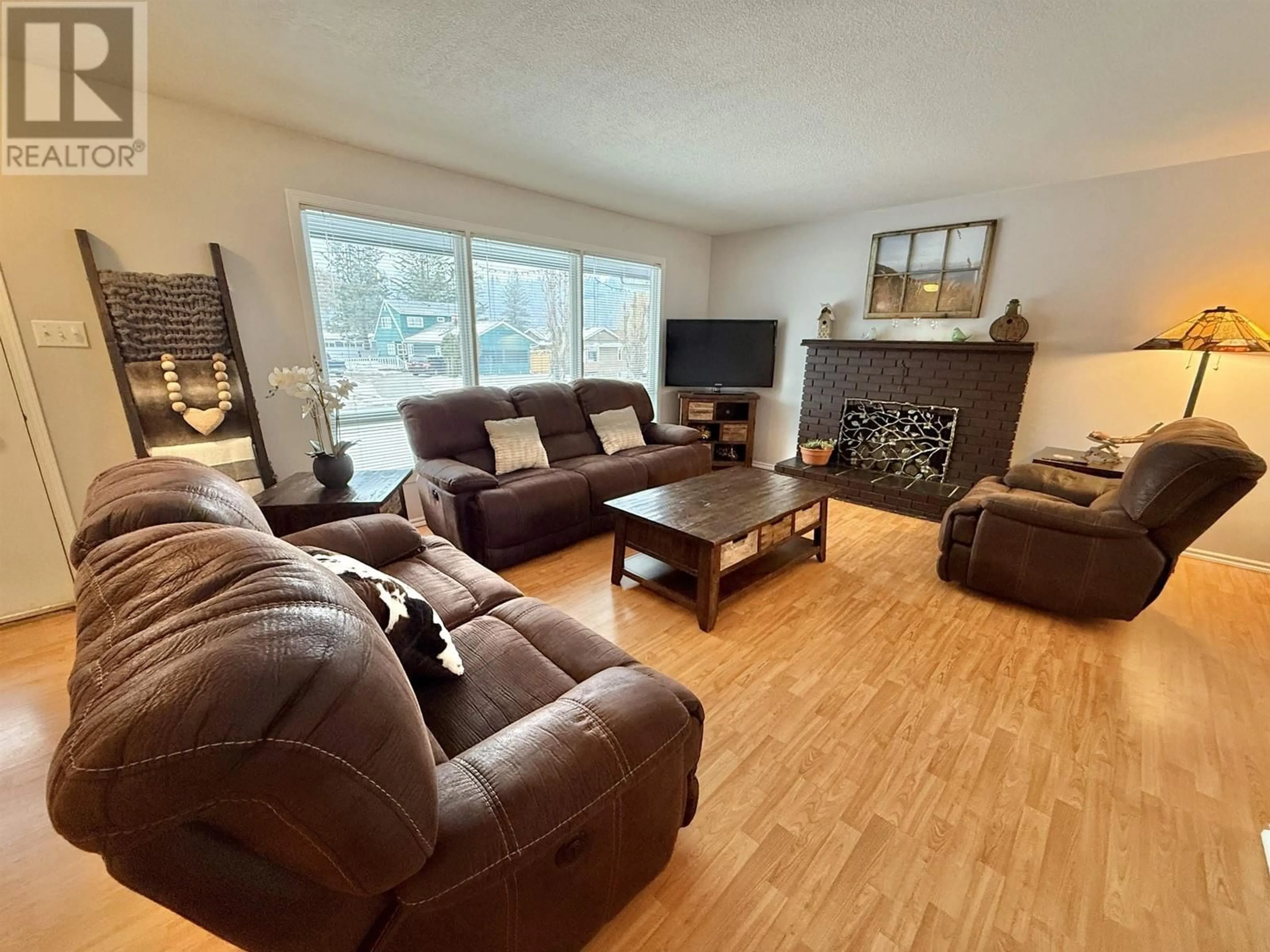 Living room with furniture, wood/laminate floor for 239 LAZZARIN STREET, Quesnel British Columbia V2J3H1