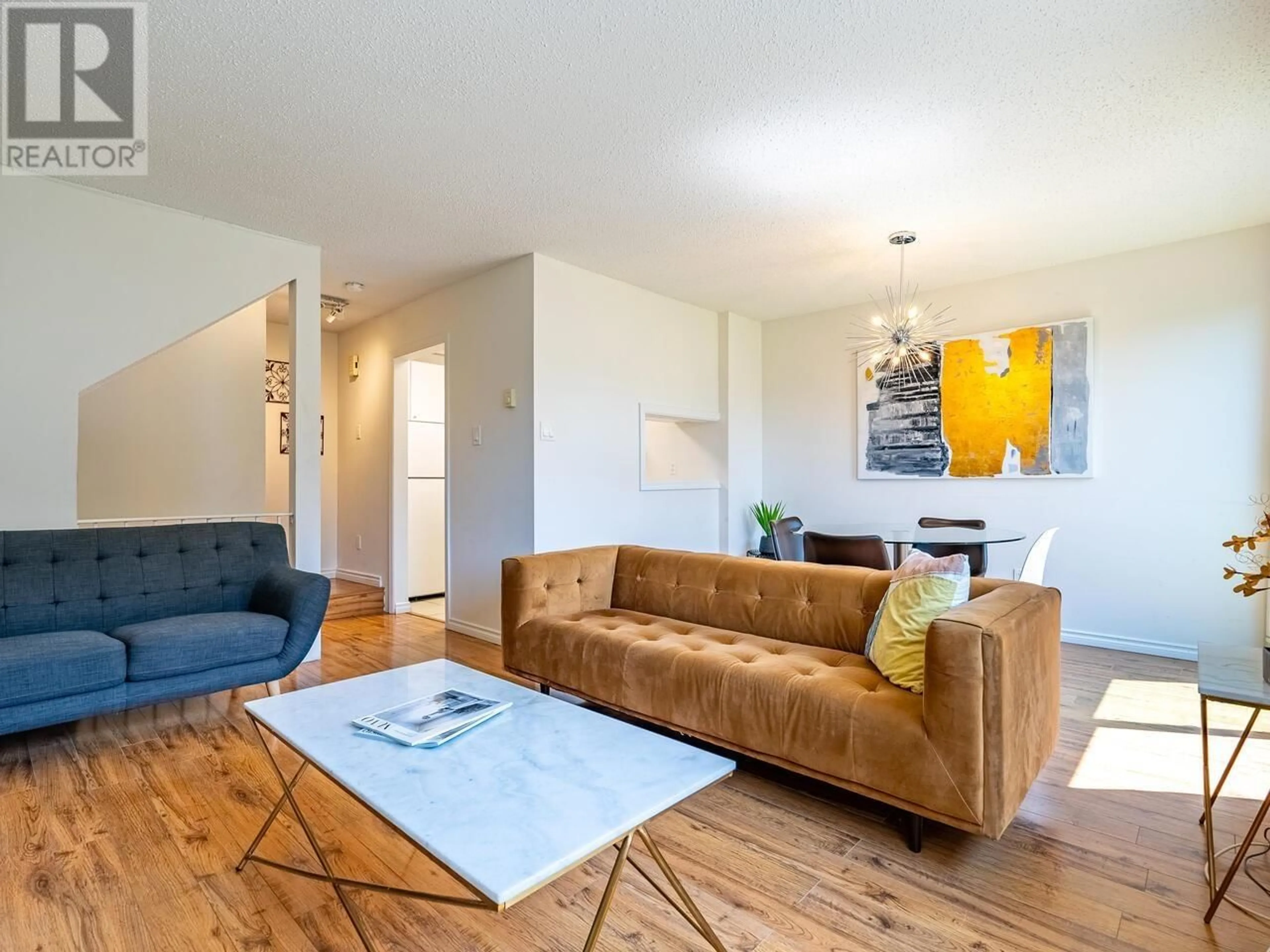 Living room with furniture, wood/laminate floor for 211 8180 COLONIAL DRIVE, Richmond British Columbia V7C4T7