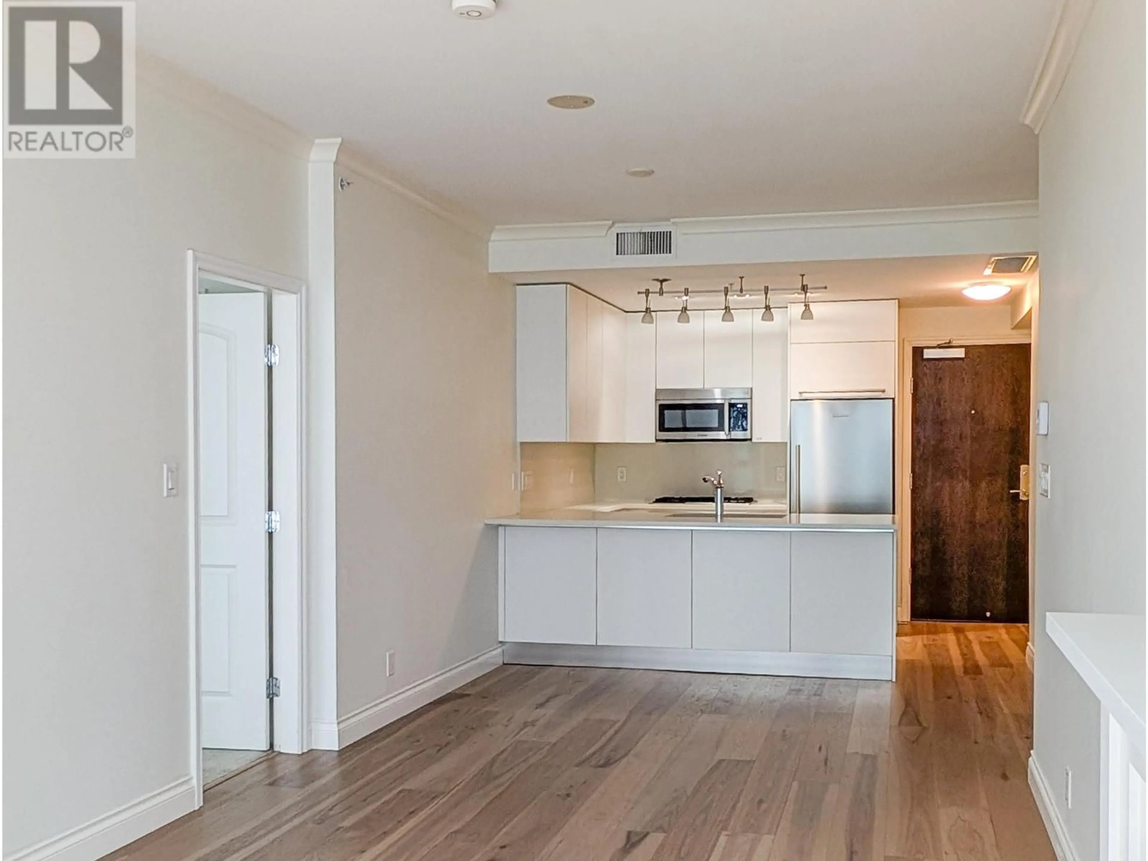 Open concept kitchen, wood/laminate floor for 404 199 VICTORY SHIP WAY, North Vancouver British Columbia V9L0E2