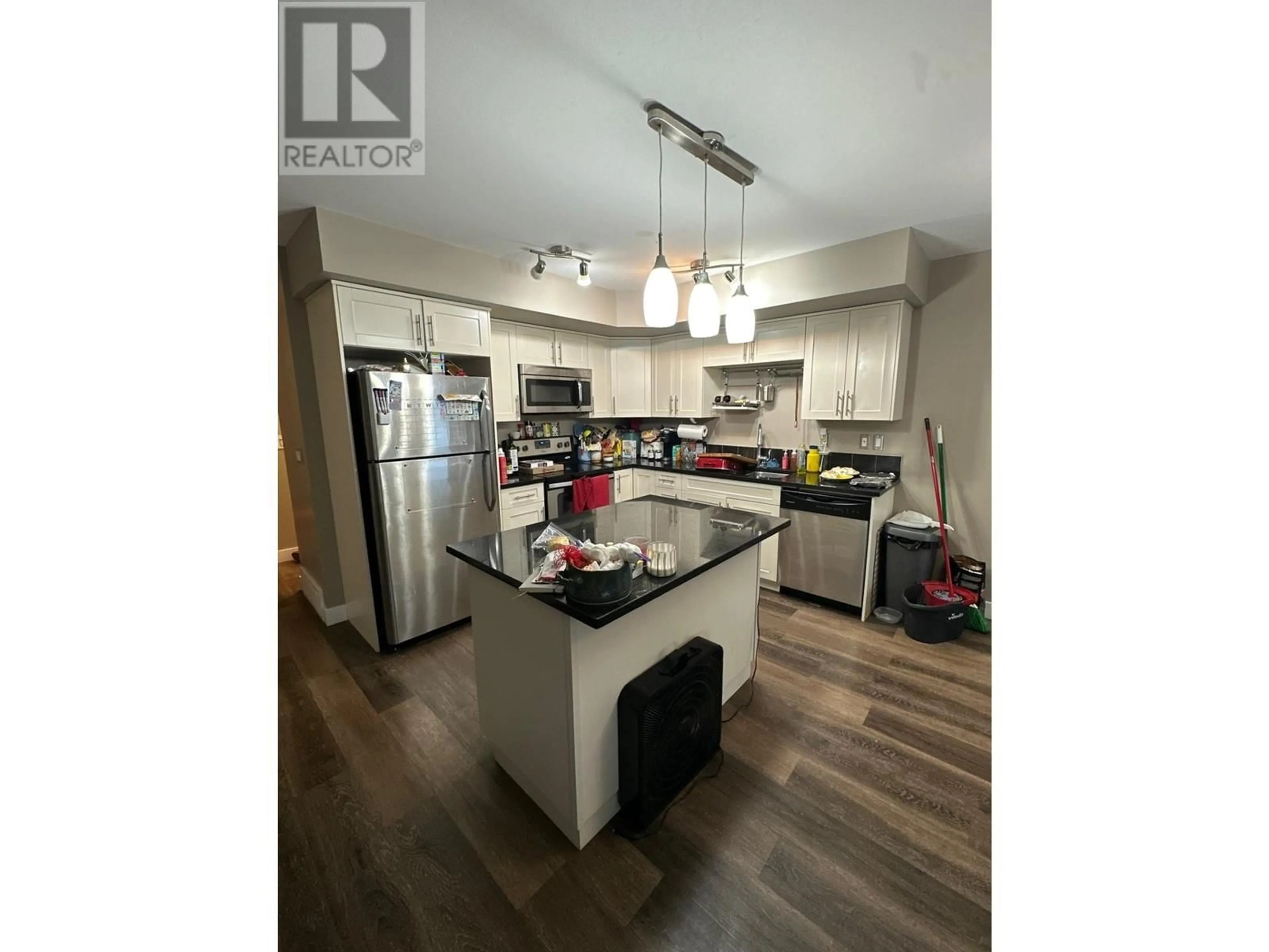 Open concept kitchen, wood/laminate floor for 138 10104 114A AVENUE, Fort St. John British Columbia V1J8K6