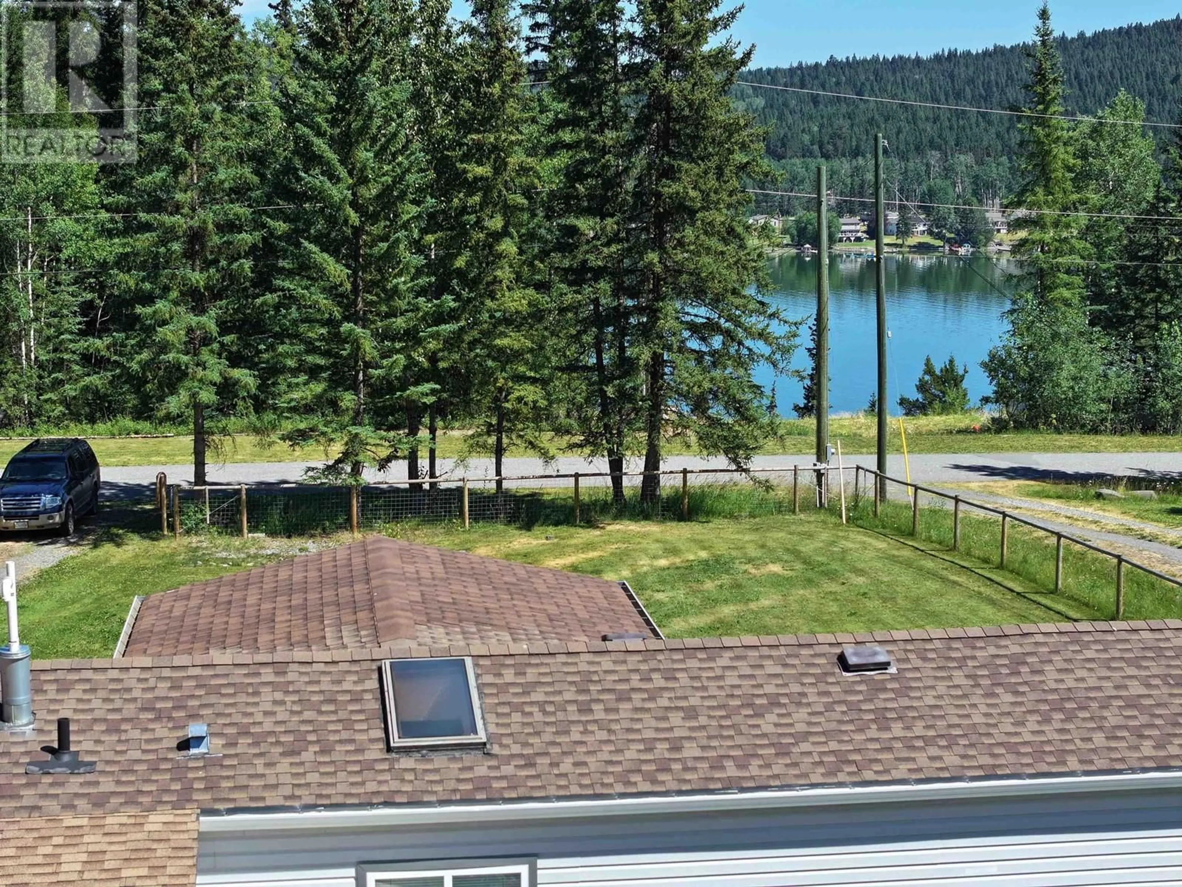 A pic from outside/outdoor area/front of a property/back of a property/a pic from drone, water/lake/river/ocean view for 6064 NORMAN ROAD, 100 Mile House British Columbia V0K2E3