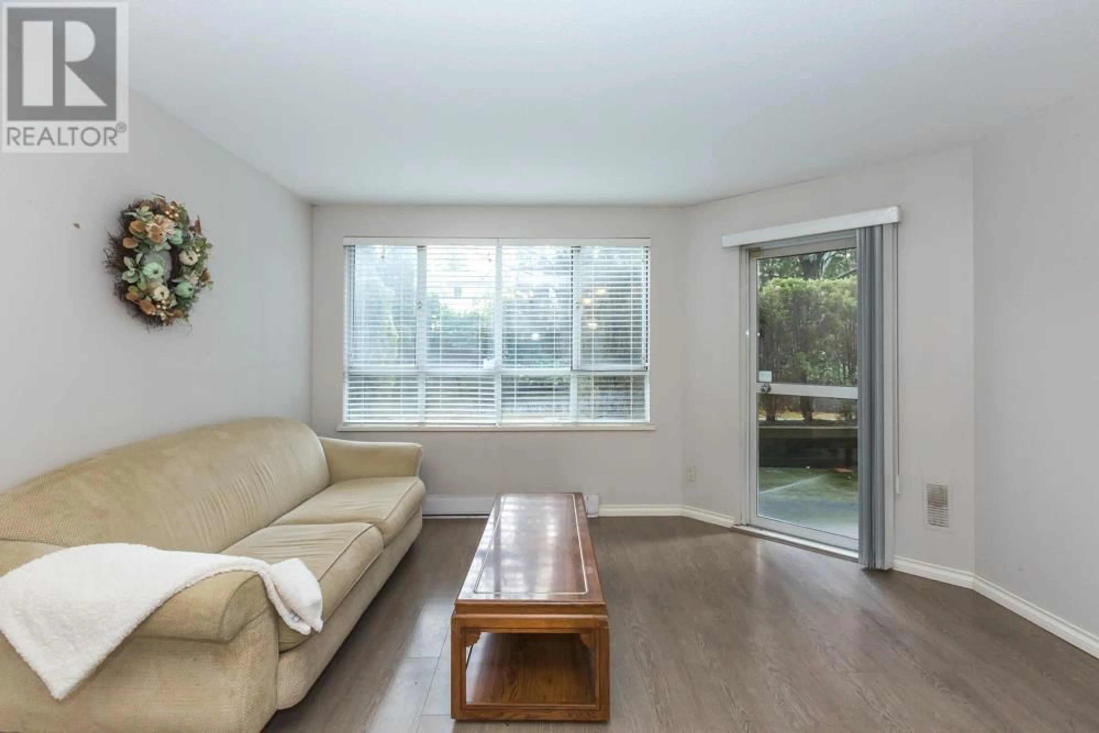 Living room with furniture, wood/laminate floor for 109 3489 ASCOT PLACE, Vancouver British Columbia V5R6B6