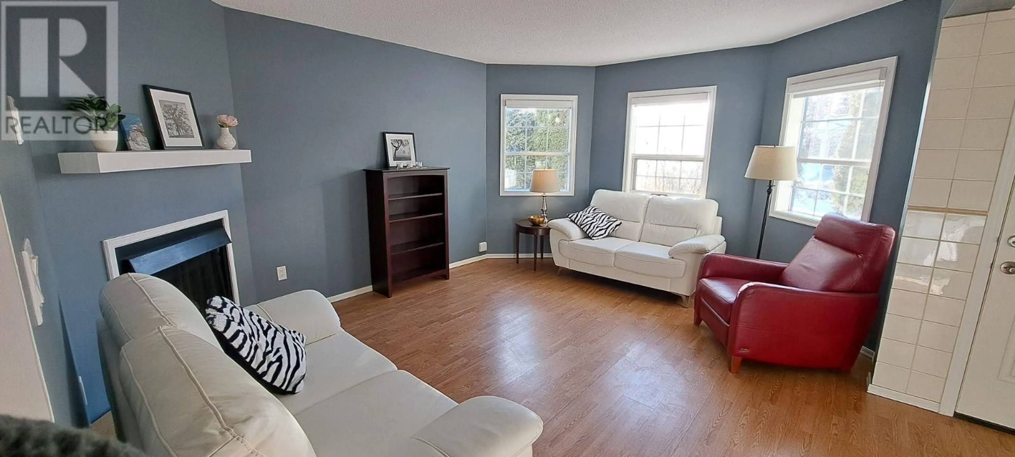 Living room with furniture, wood/laminate floor for 102 106 MCDERMID DRIVE, Prince George British Columbia V2M4T6