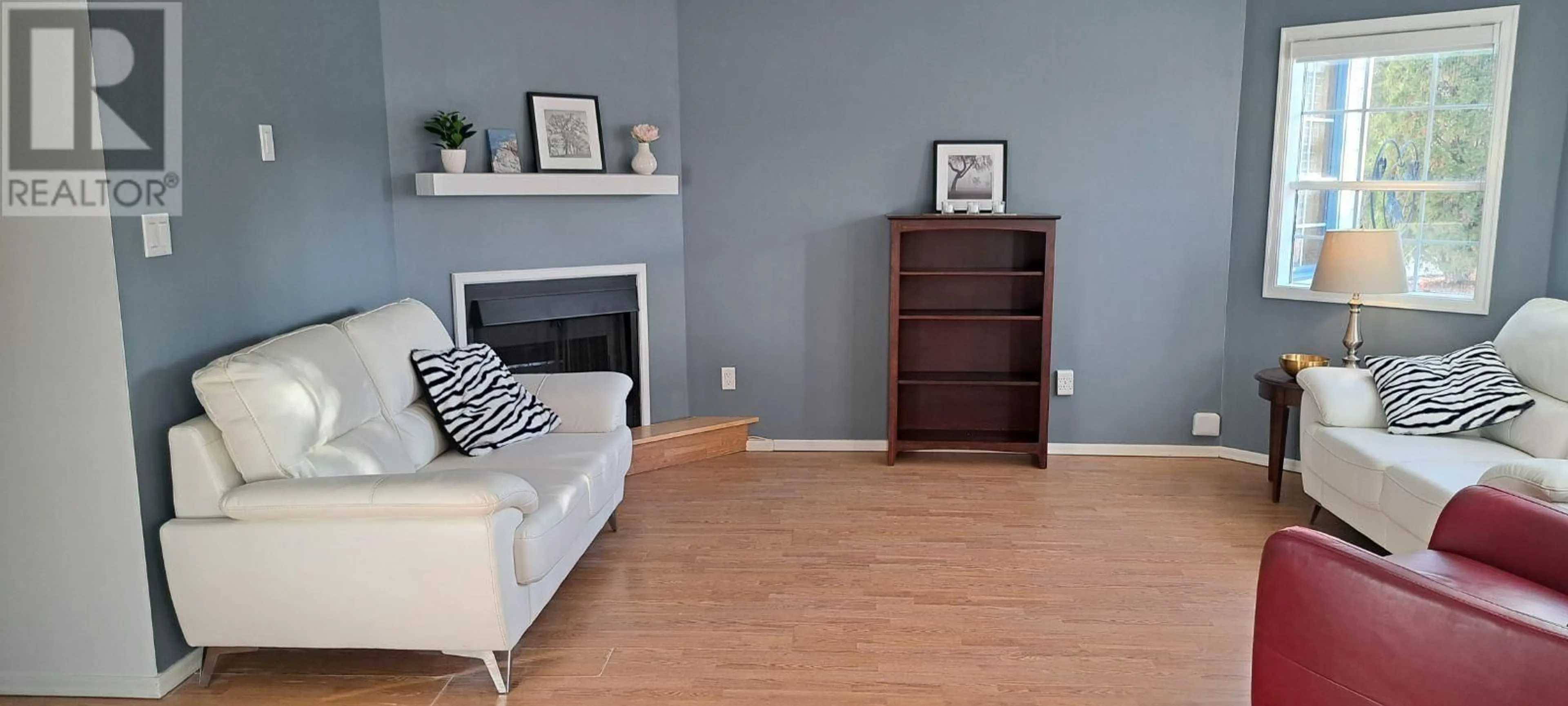 Living room with furniture, wood/laminate floor for 102 106 MCDERMID DRIVE, Prince George British Columbia V2M4T6