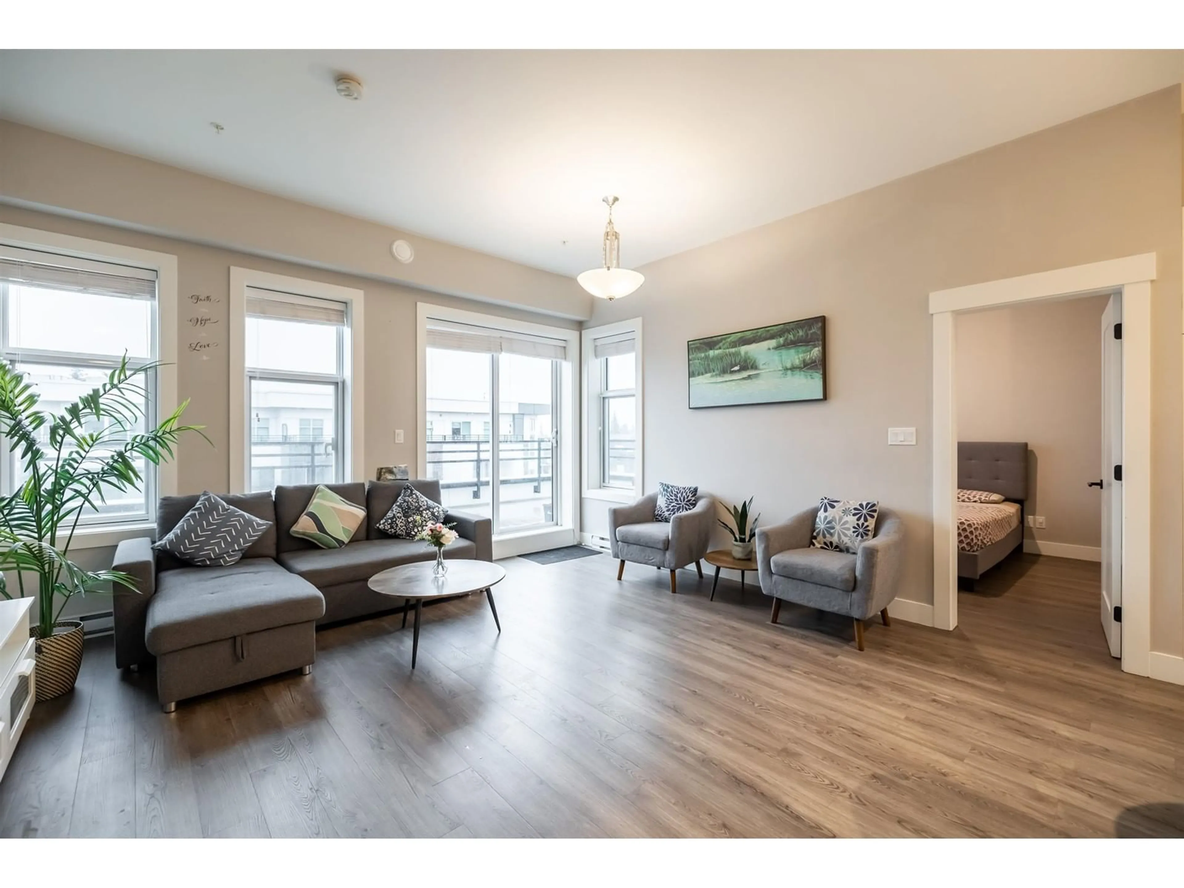 Living room with furniture, wood/laminate floor for A602 20838 78B AVENUE, Langley British Columbia V2Y3M1