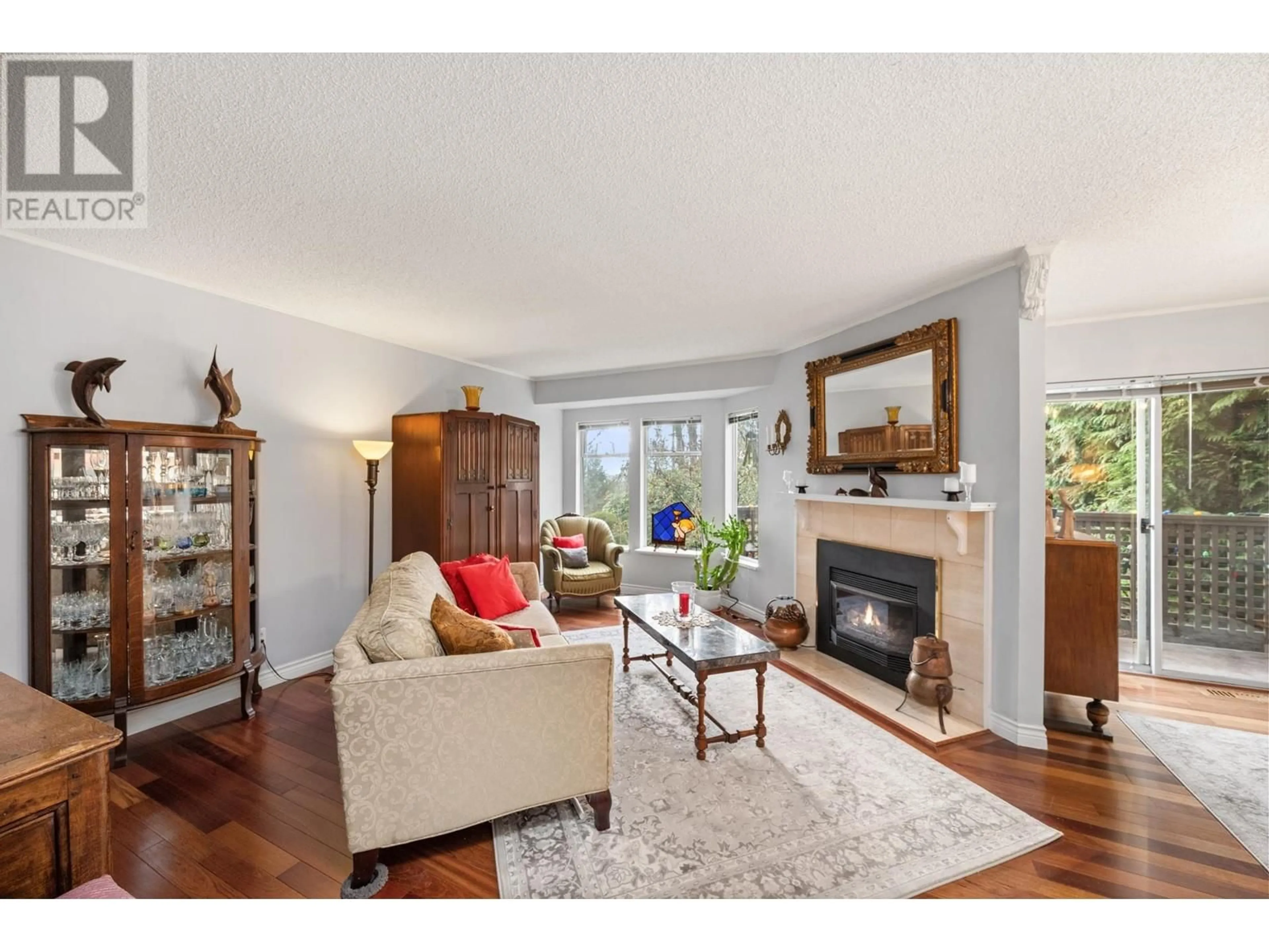 Living room with furniture, wood/laminate floor for 8886 LARKFIELD DRIVE, Burnaby British Columbia V5A4L2