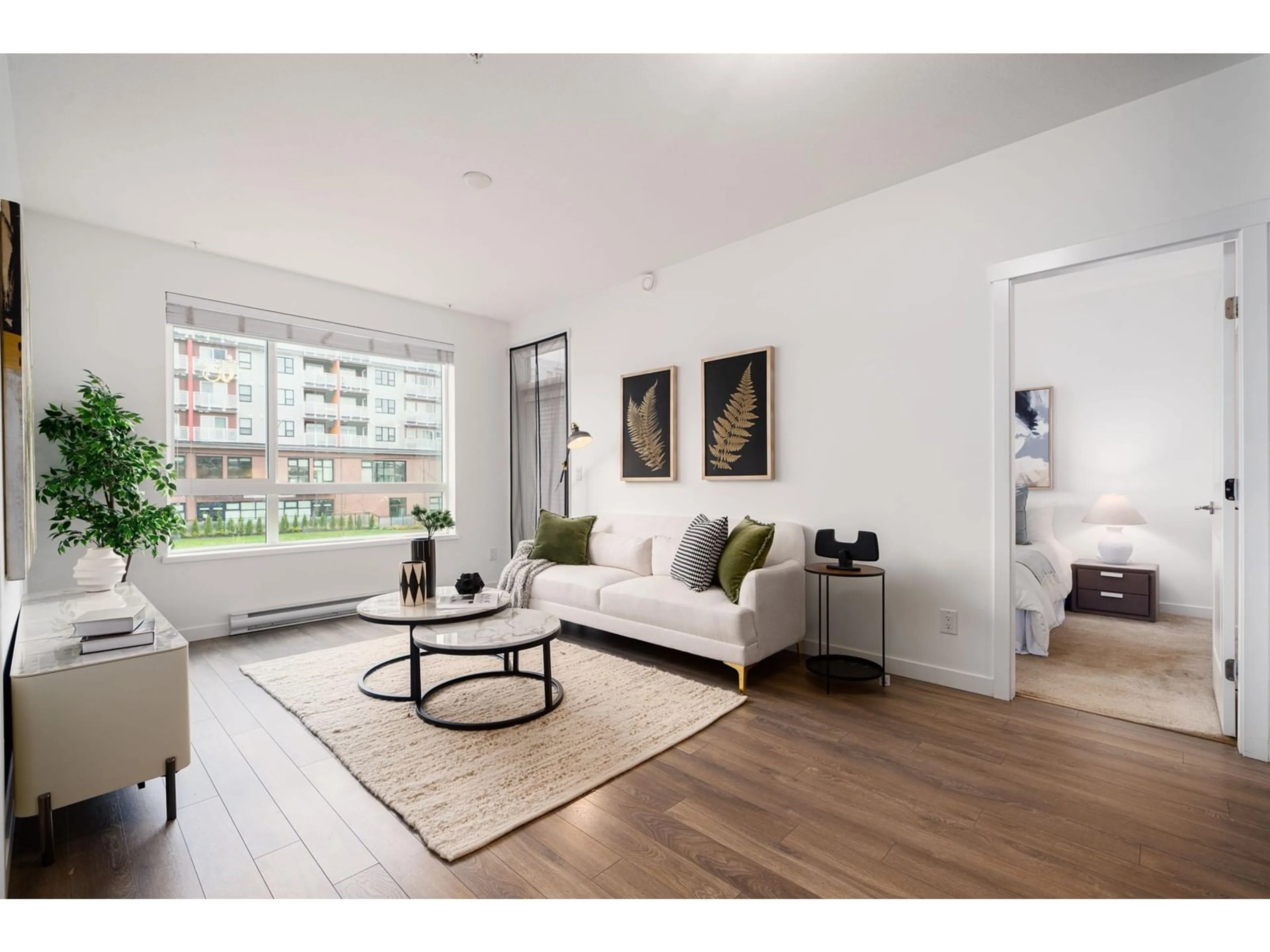 Living room with furniture, wood/laminate floor for 213 13628 81A AVENUE, Surrey British Columbia V3W3E2