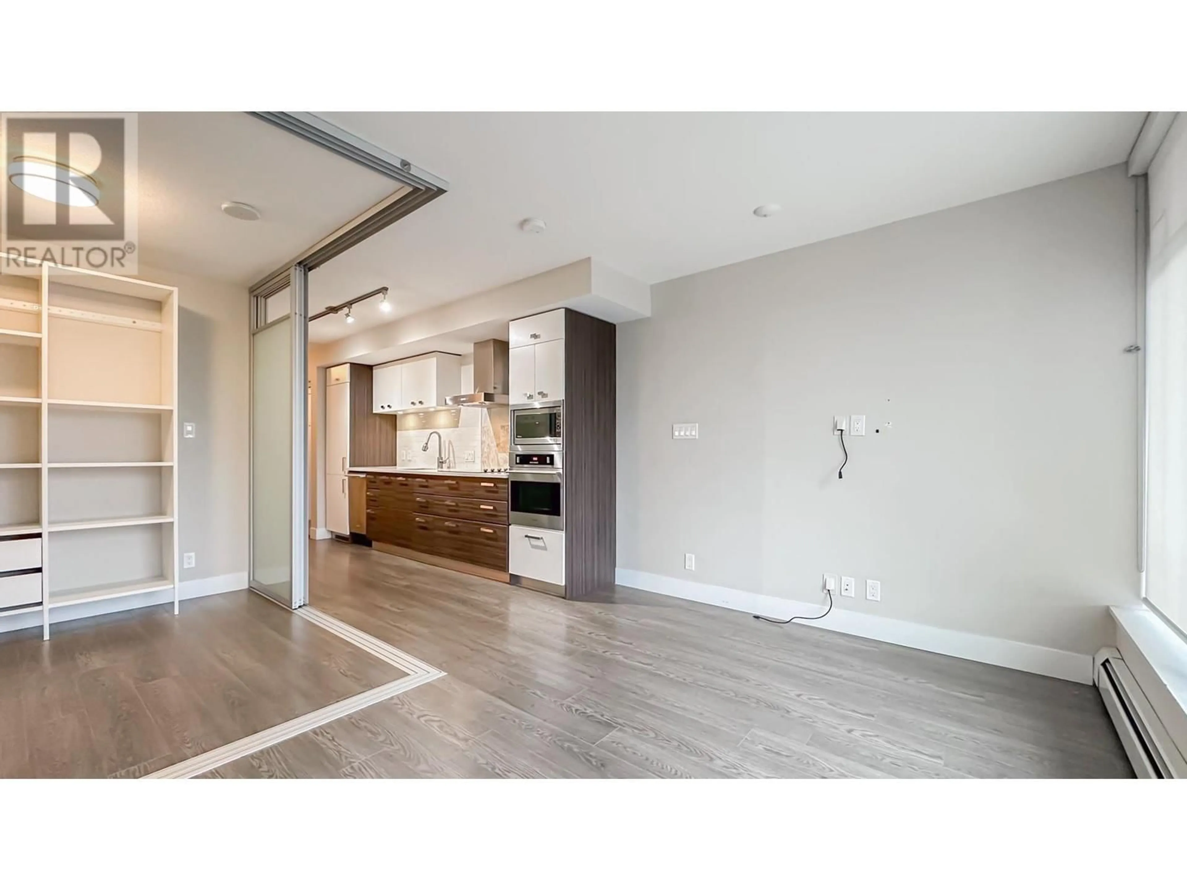 Open concept kitchen, wood/laminate floor for 205 1783 MANITOBA STREET, Vancouver British Columbia V5Y0K1