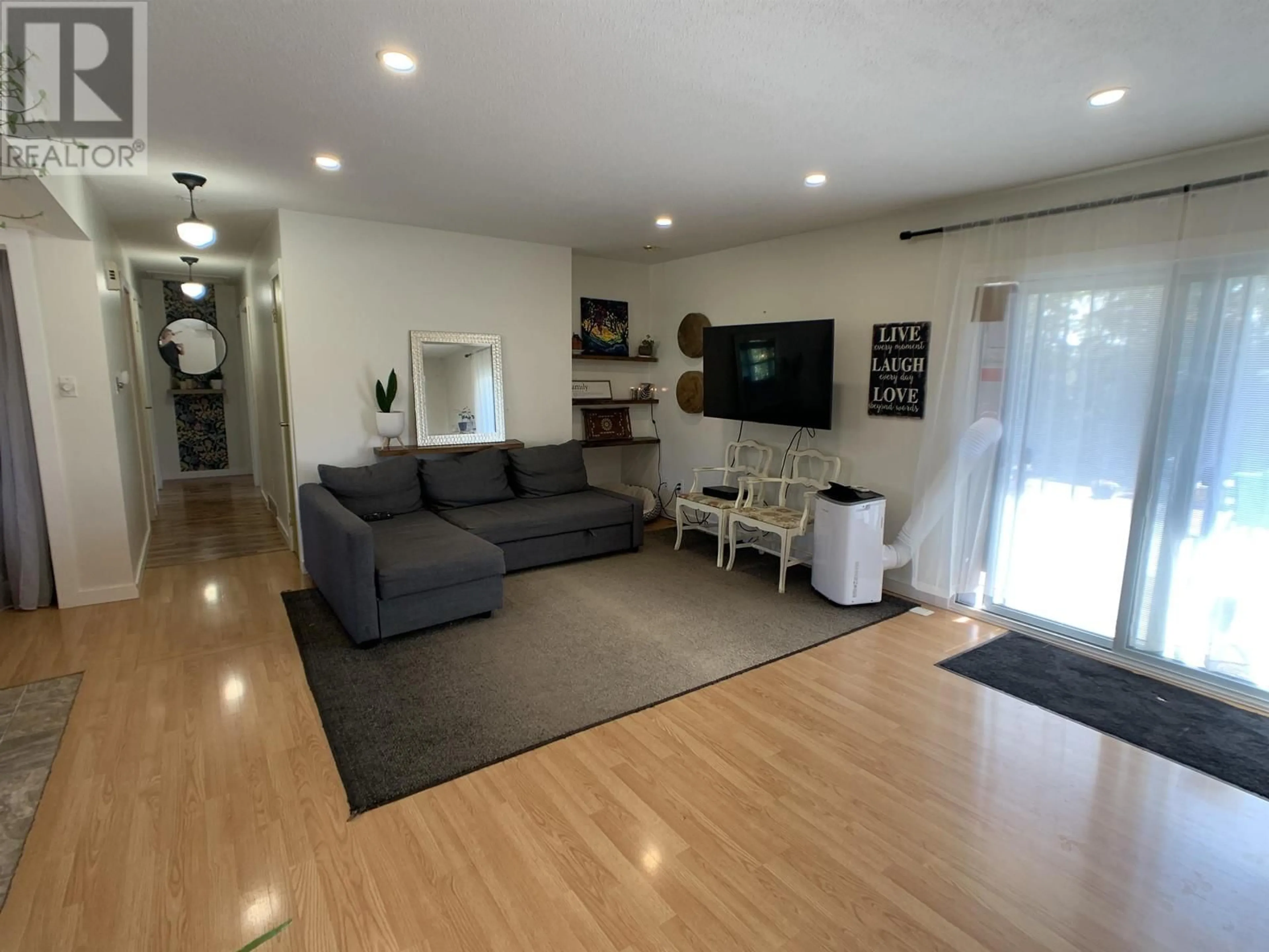 Living room with furniture, wood/laminate floor for 5524 53 STREET, Fort Nelson British Columbia V0C1R0