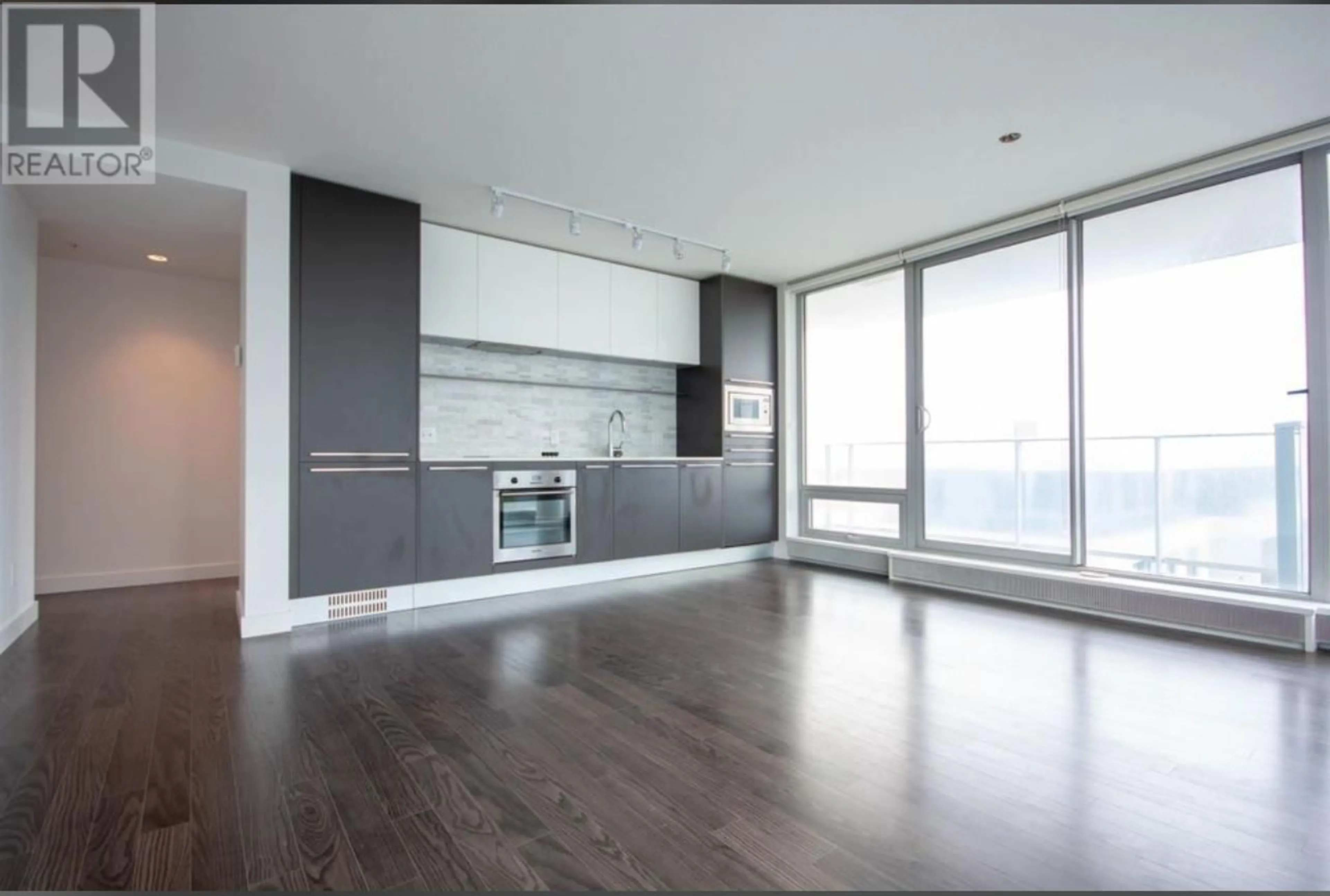 Open concept kitchen, wood/laminate floor for 606 8031 NUNAVUT LANE, Vancouver British Columbia V5X0C9