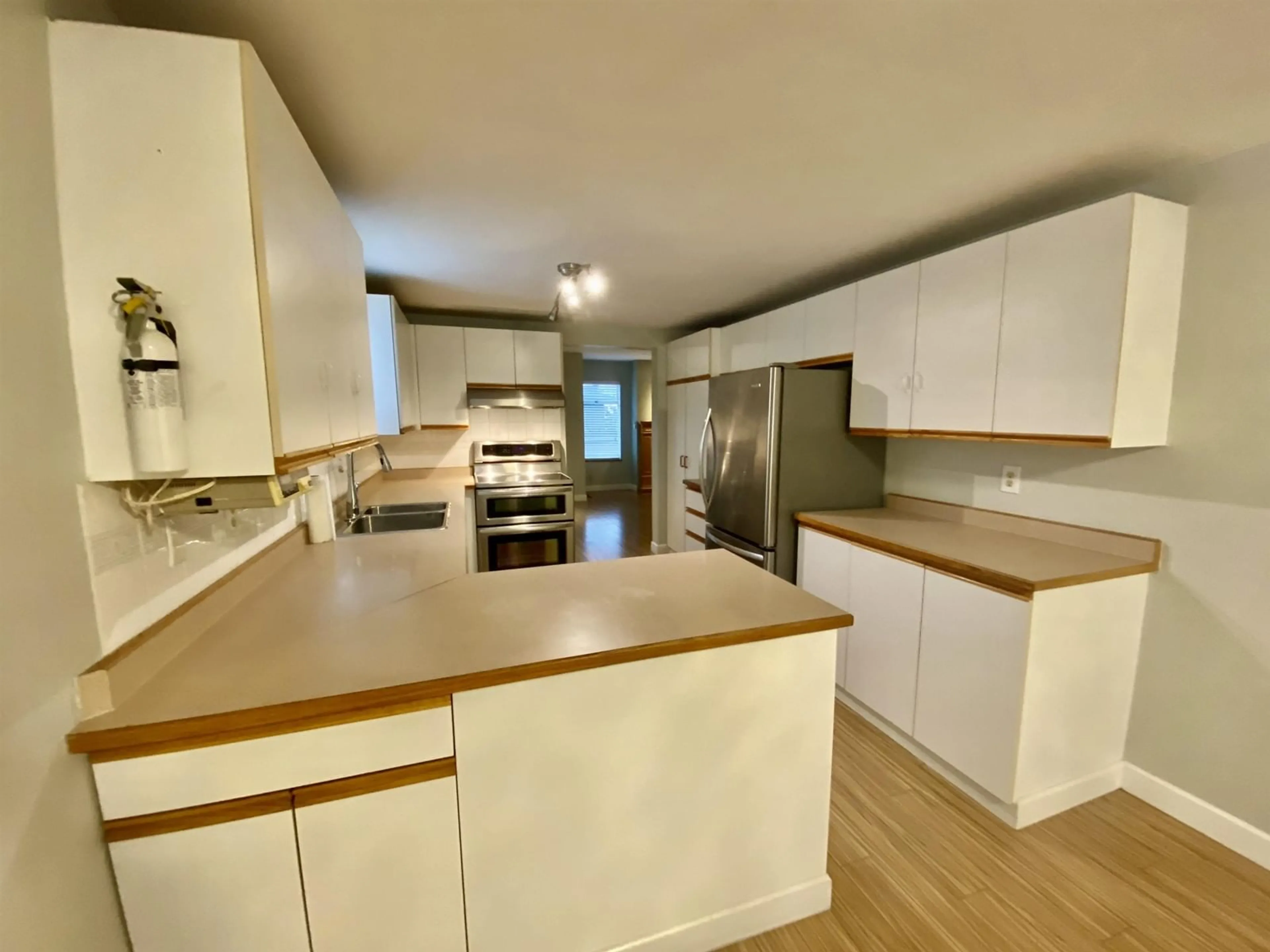 Open concept kitchen, wood/laminate floor for 17 11880 82 AVENUE, Delta British Columbia V4C8C5