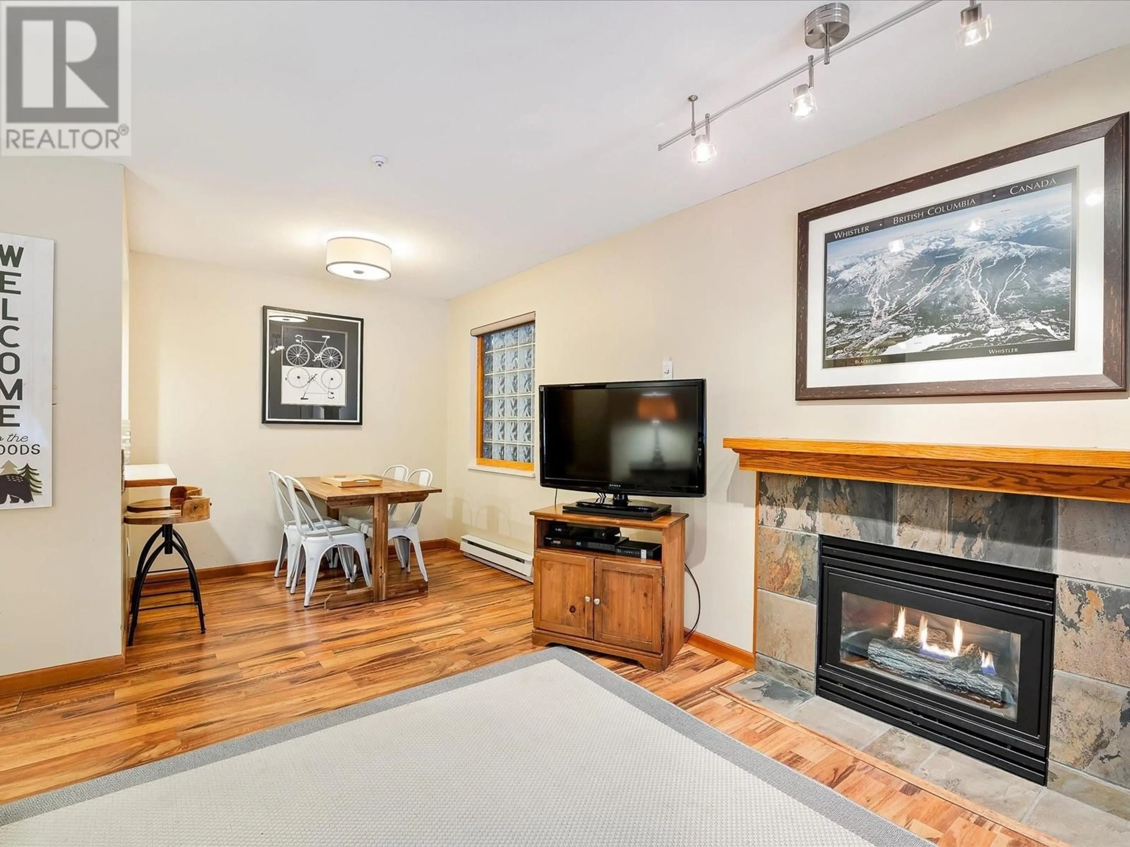 Living room with furniture, wood/laminate floor for 110 4355 NORTHLANDS BOULEVARD, Whistler British Columbia V8E1C3