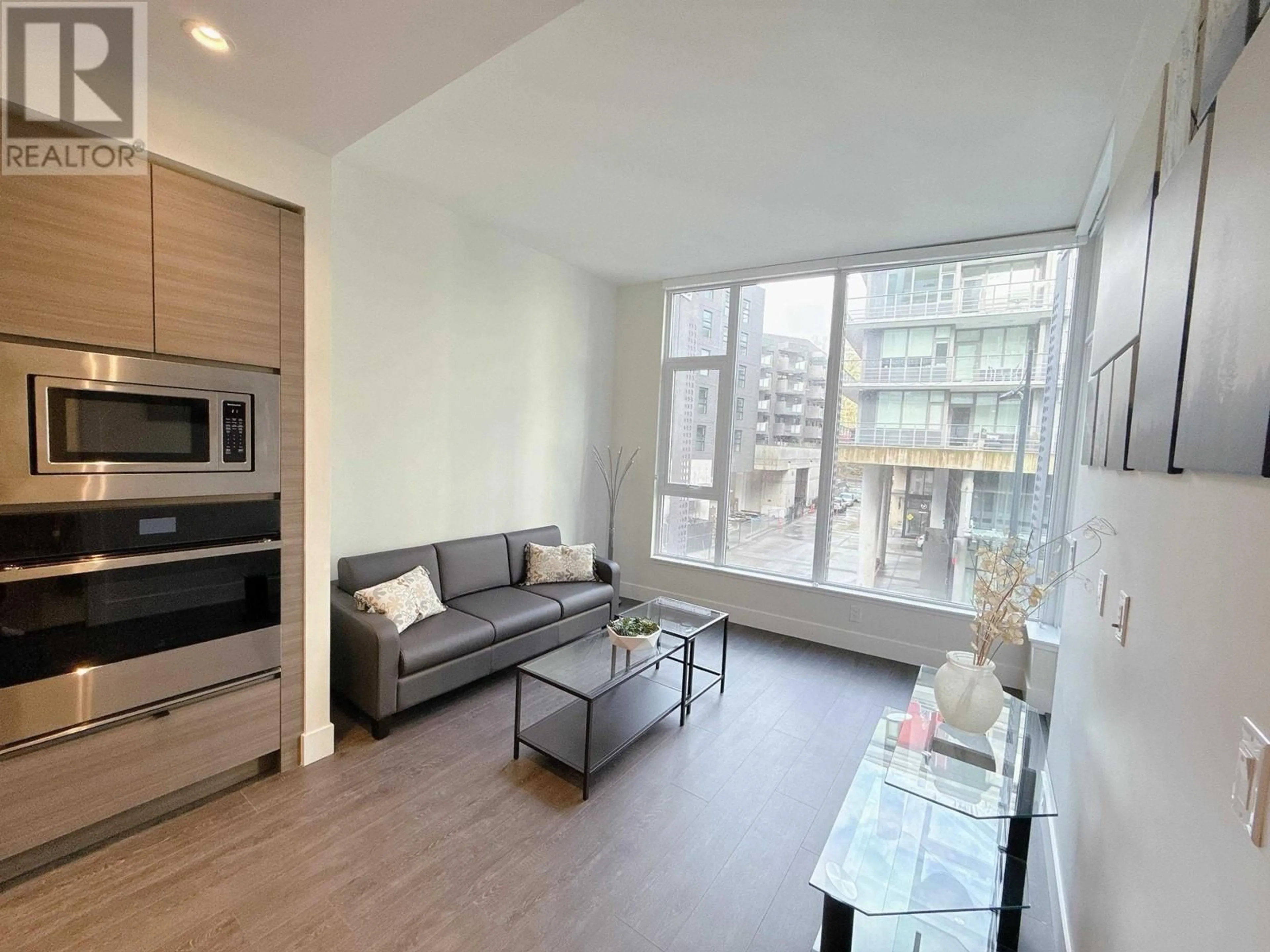 Living room with furniture, wood/laminate floor for 321 3438 SAWMILL CRESCENT, Vancouver British Columbia V5S0E3