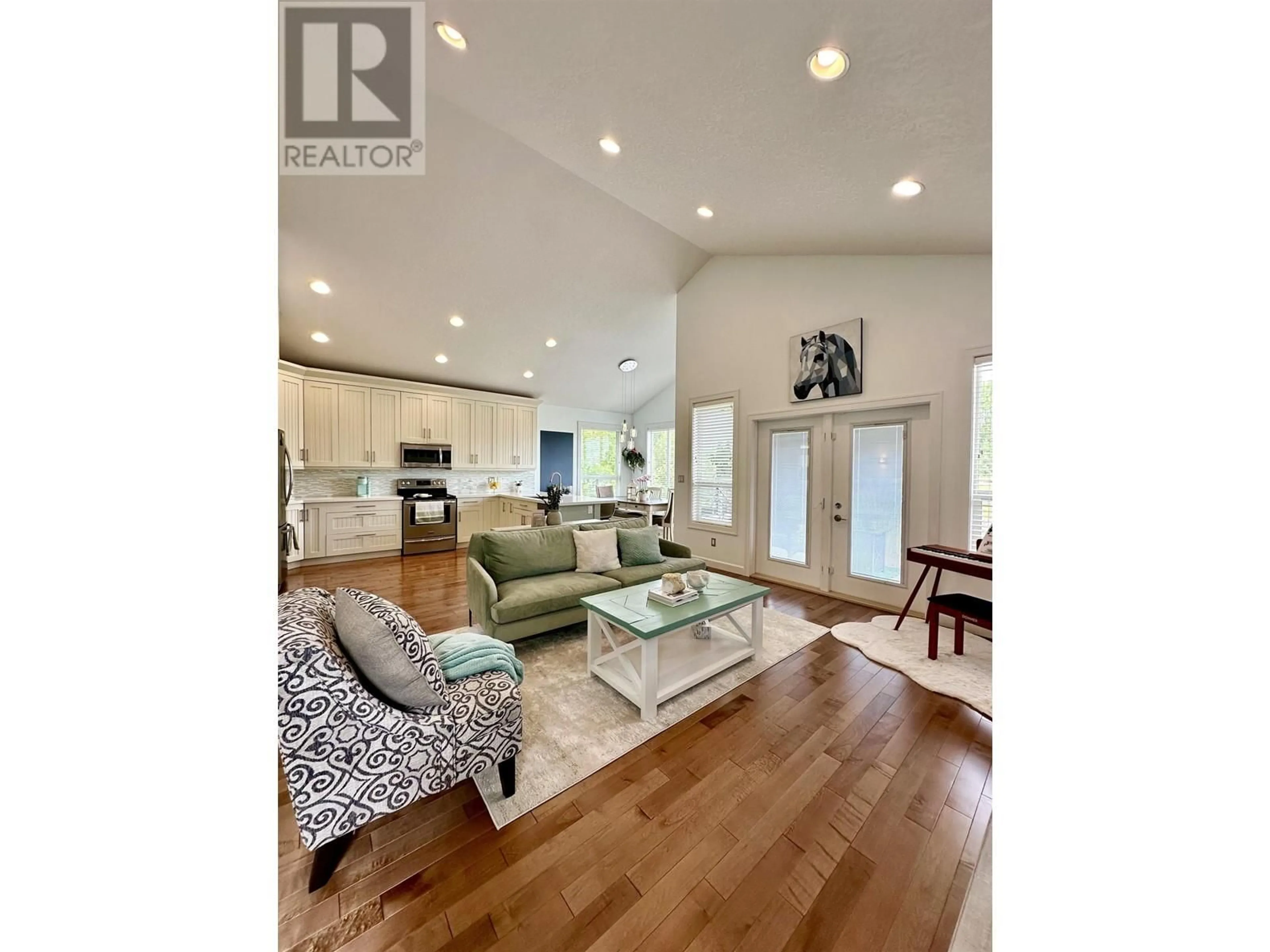 Living room with furniture, wood/laminate floor for 1436 OMINECA PLACE, Prince George British Columbia V2N0B7