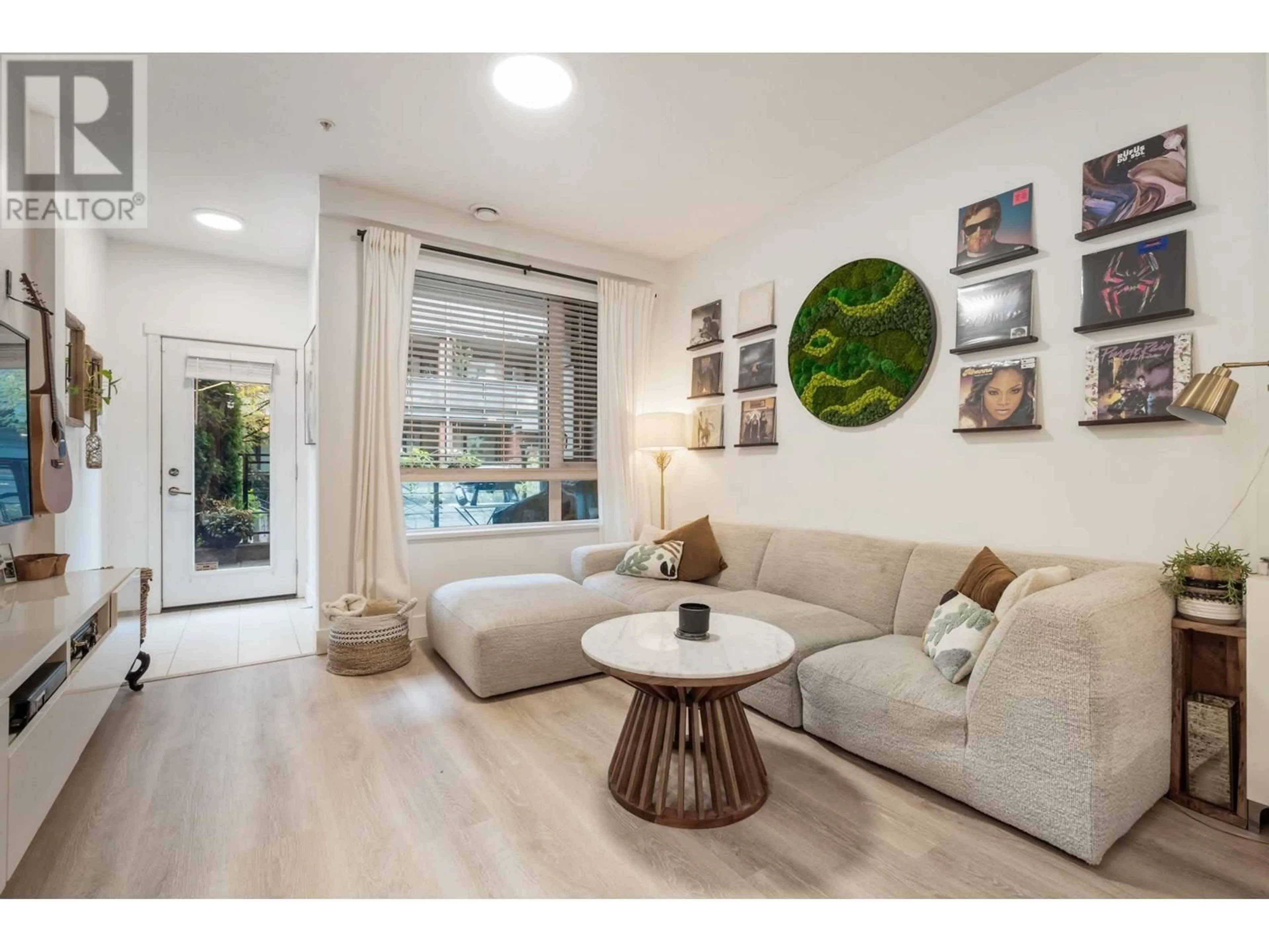 Living room with furniture, wood/laminate floor for 107 3133 RIVERWALK AVENUE, Vancouver British Columbia V5S0A7