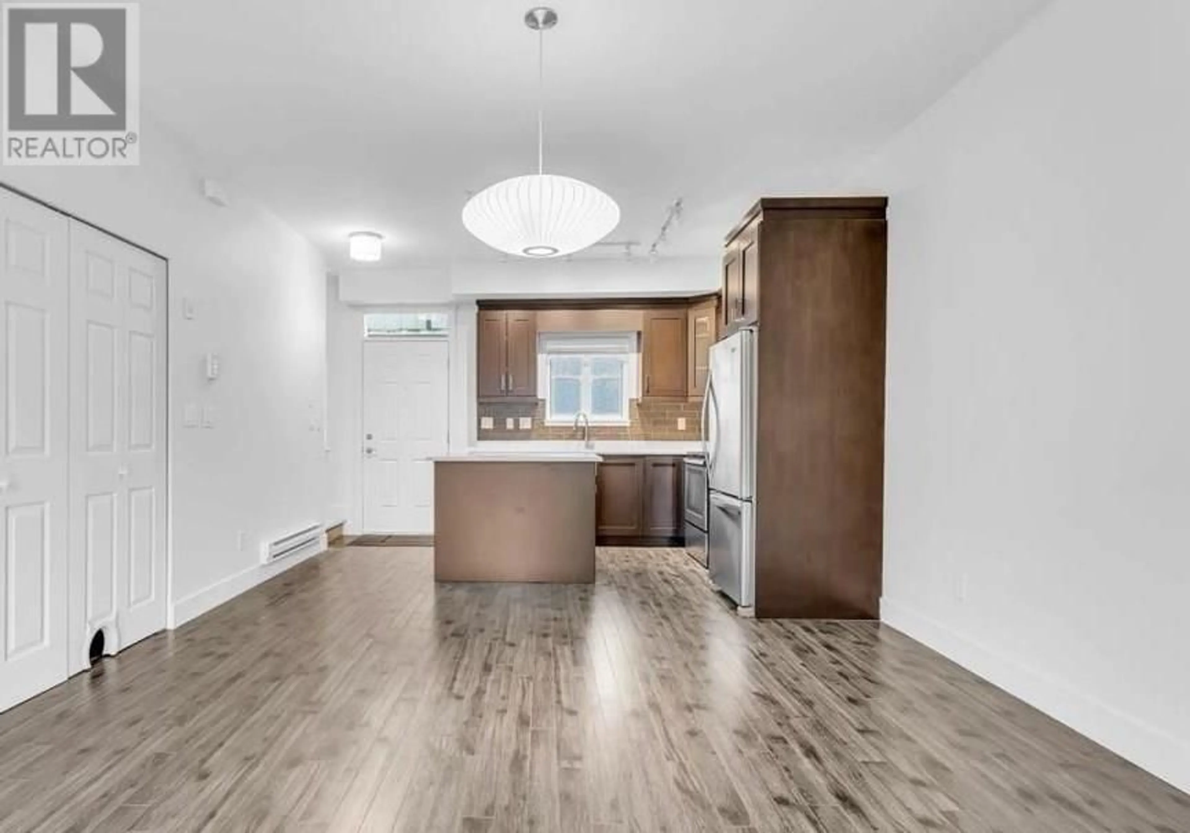 Open concept kitchen, wood/laminate floor for 211 2273 TRIUMPH STREET, Vancouver British Columbia V5L1L2