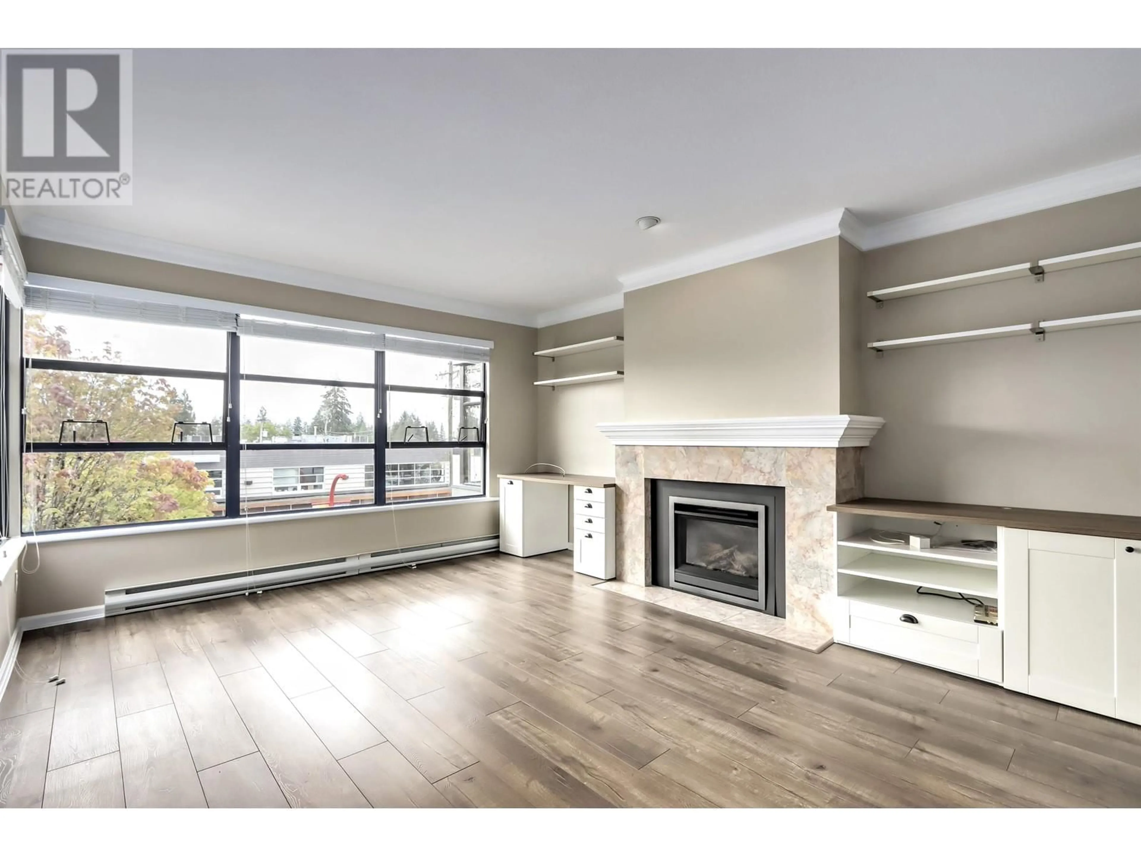 Living room with furniture, wood/laminate floor for 301 3151 WOODBINE DRIVE, North Vancouver British Columbia V7R2S4