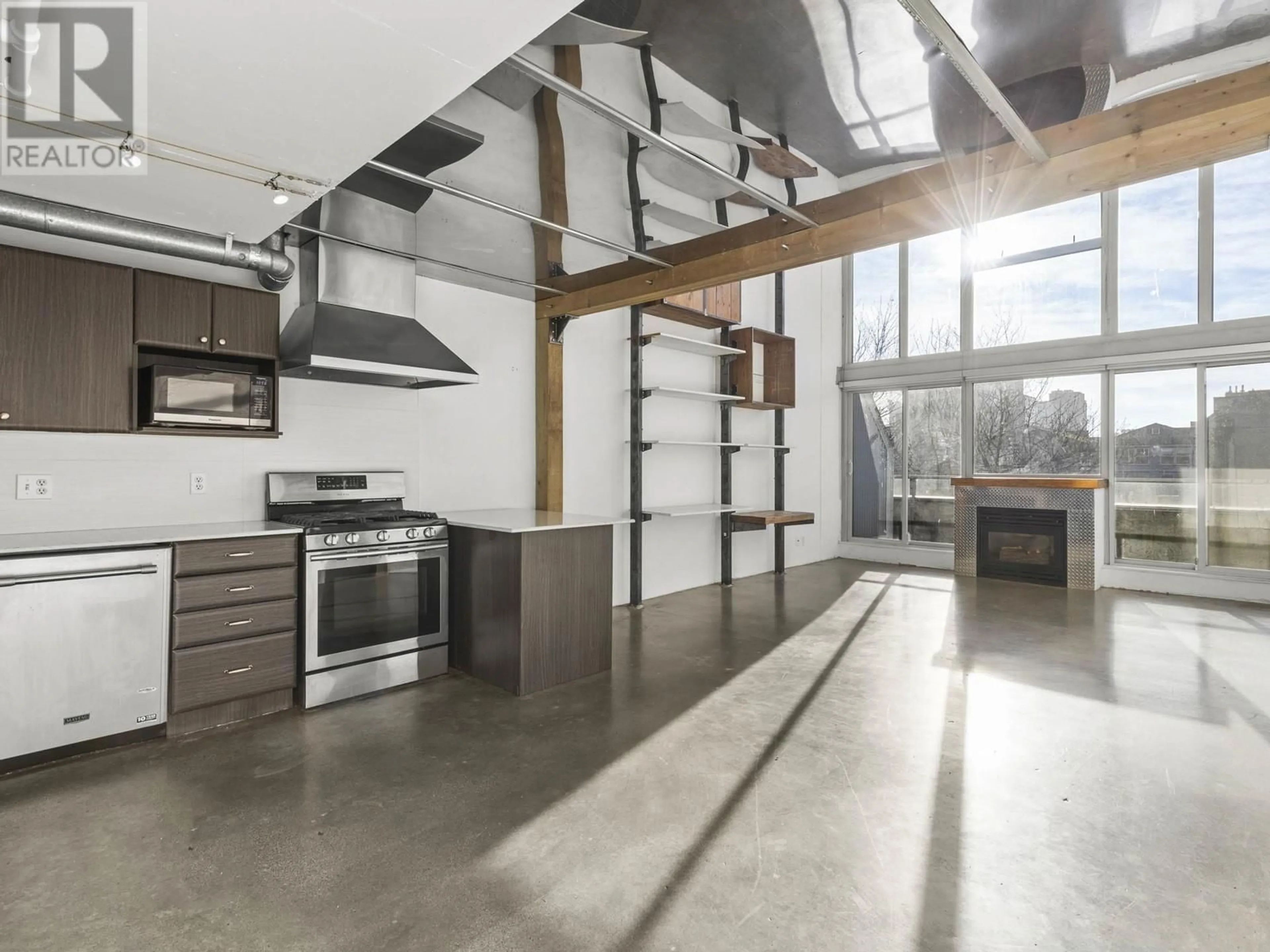 Open concept kitchen, cement floor for 409 289 ALEXANDER STREET, Vancouver British Columbia V6A4H6