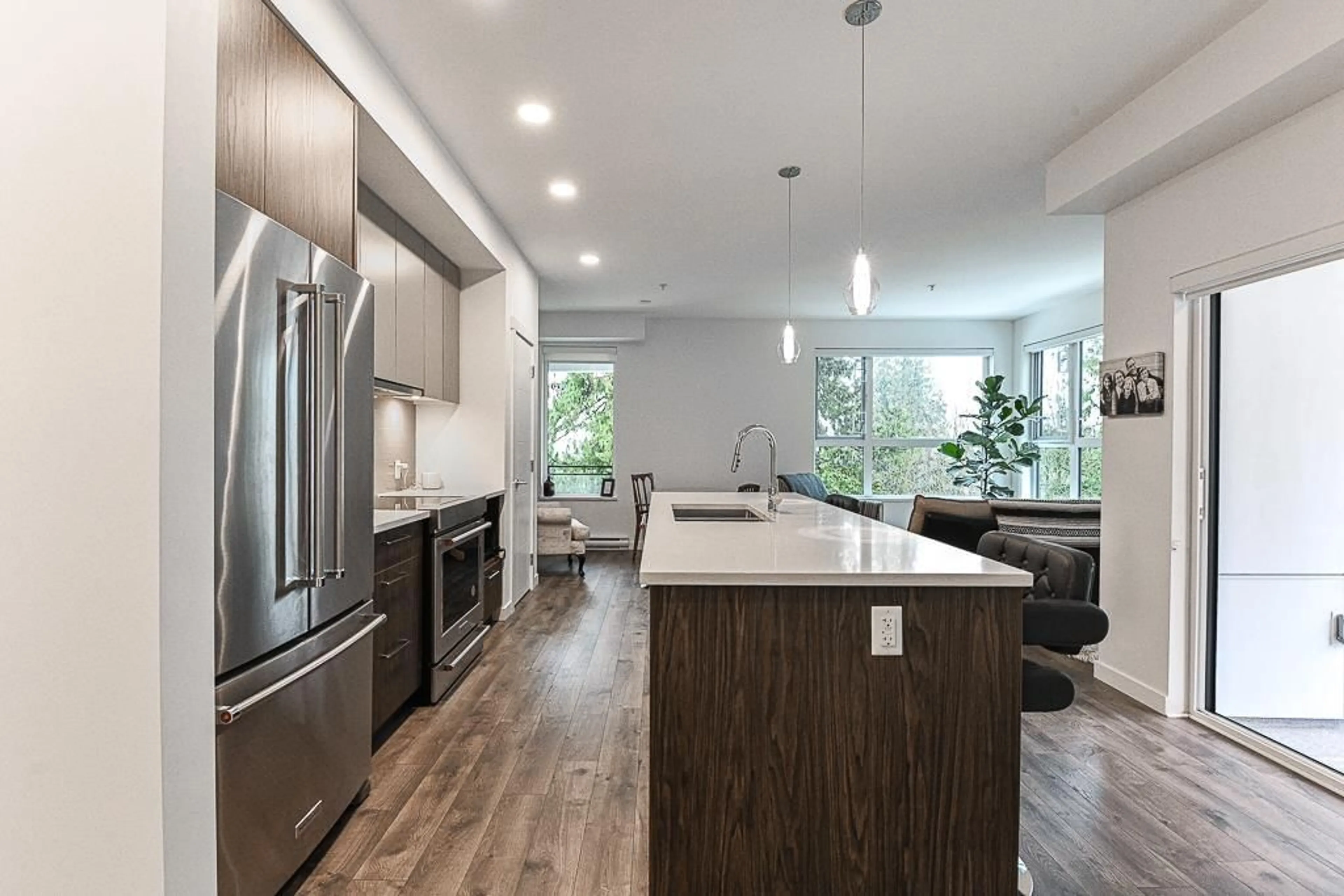 Open concept kitchen, wood/laminate floor for 303 3182 GLADWIN ROAD, Abbotsford British Columbia V2T0K8