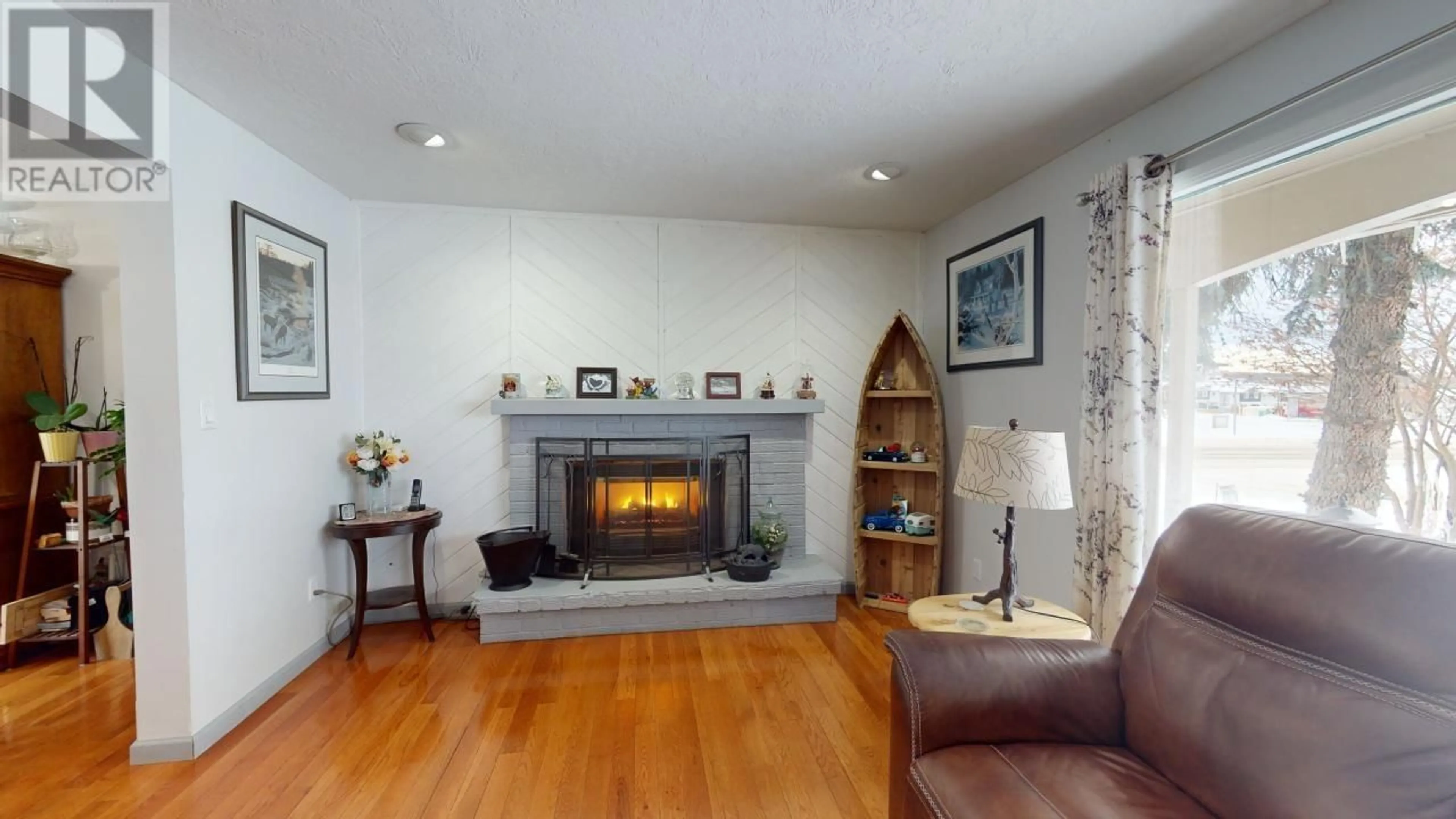 Living room with furniture, wood/laminate floor for 9917 114 AVENUE, Fort St. John British Columbia V1J4R8