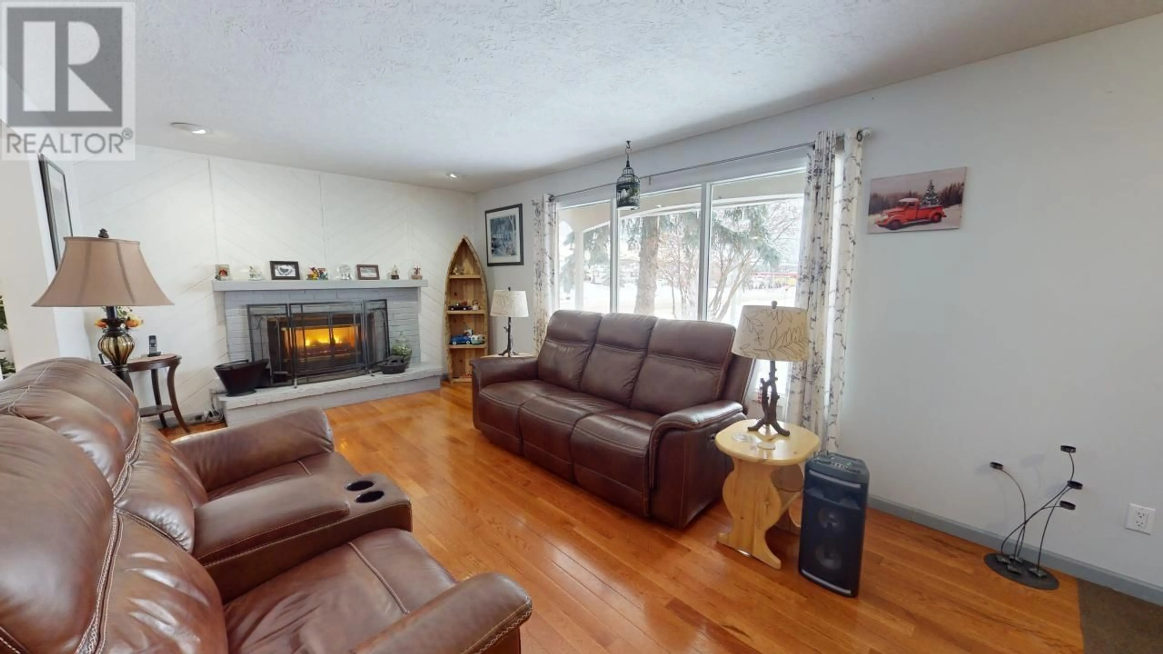 Living room with furniture, wood/laminate floor for 9917 114 AVENUE, Fort St. John British Columbia V1J4R8