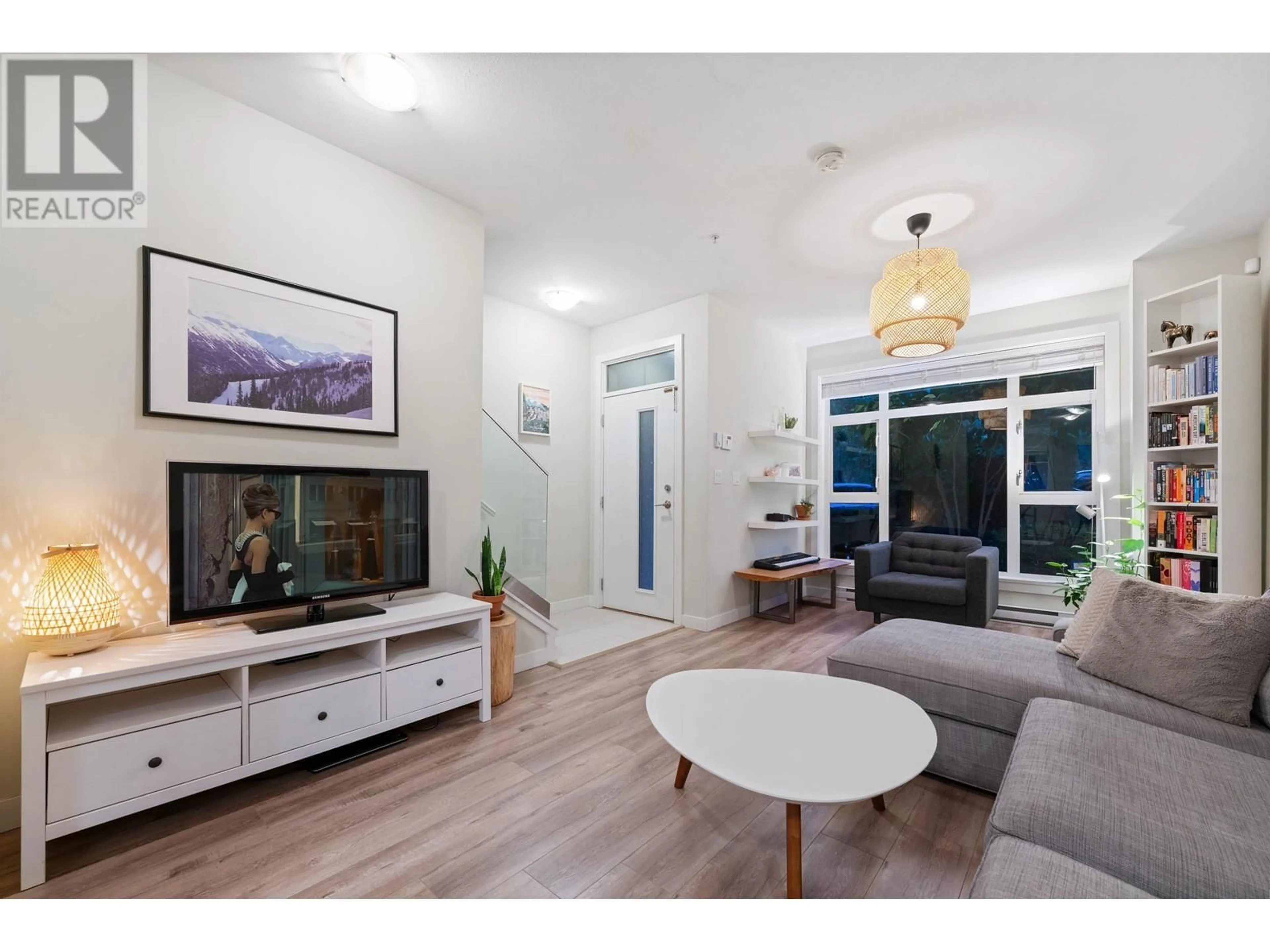 Living room with furniture, wood/laminate floor for 205 2135 HERITAGE PARK LANE, North Vancouver British Columbia V7H0B6