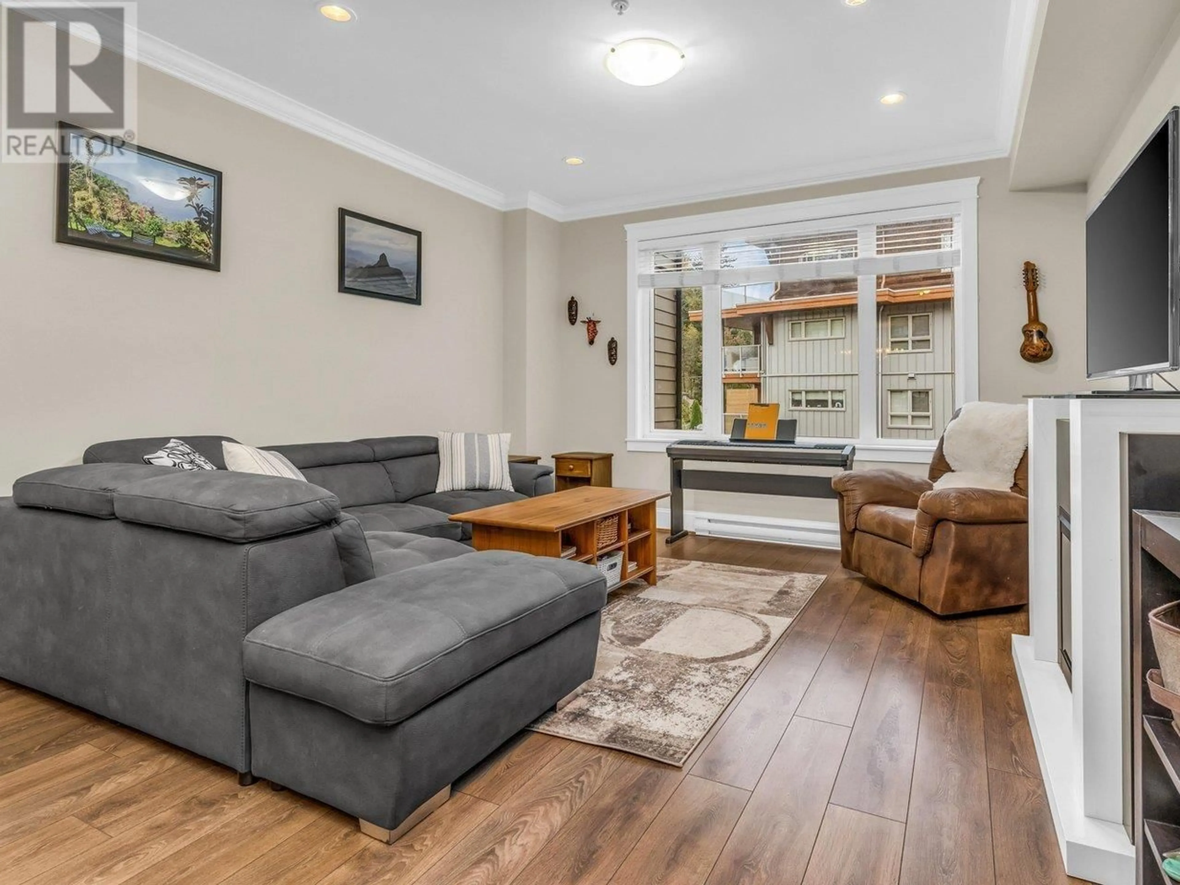 Living room with furniture, wood/laminate floor for 310 SEYMOUR RIVER PLACE, North Vancouver British Columbia V7H1S7