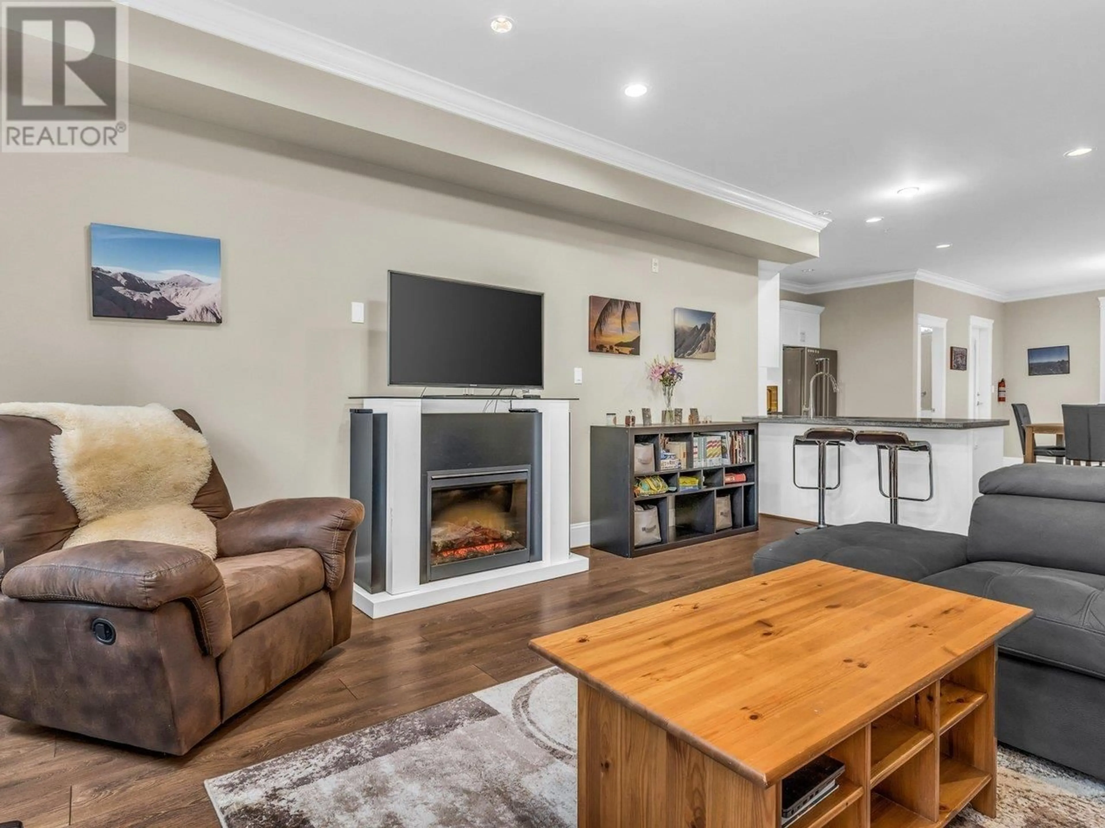 Living room with furniture, wood/laminate floor for 310 SEYMOUR RIVER PLACE, North Vancouver British Columbia V7H1S7