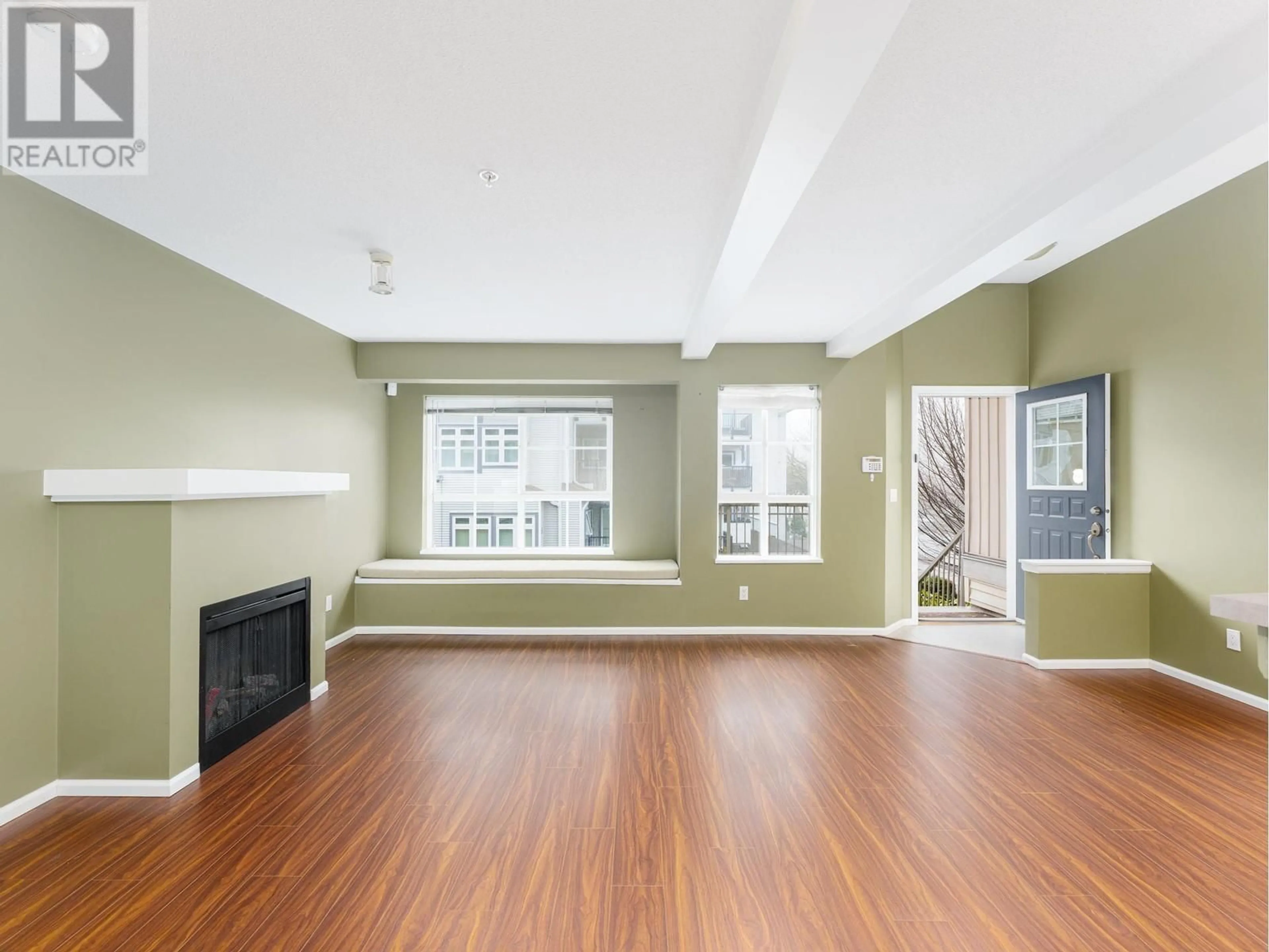 Living room with furniture, wood/laminate floor for 38 - 7088 17 AVENUE, Burnaby British Columbia V3N1K5