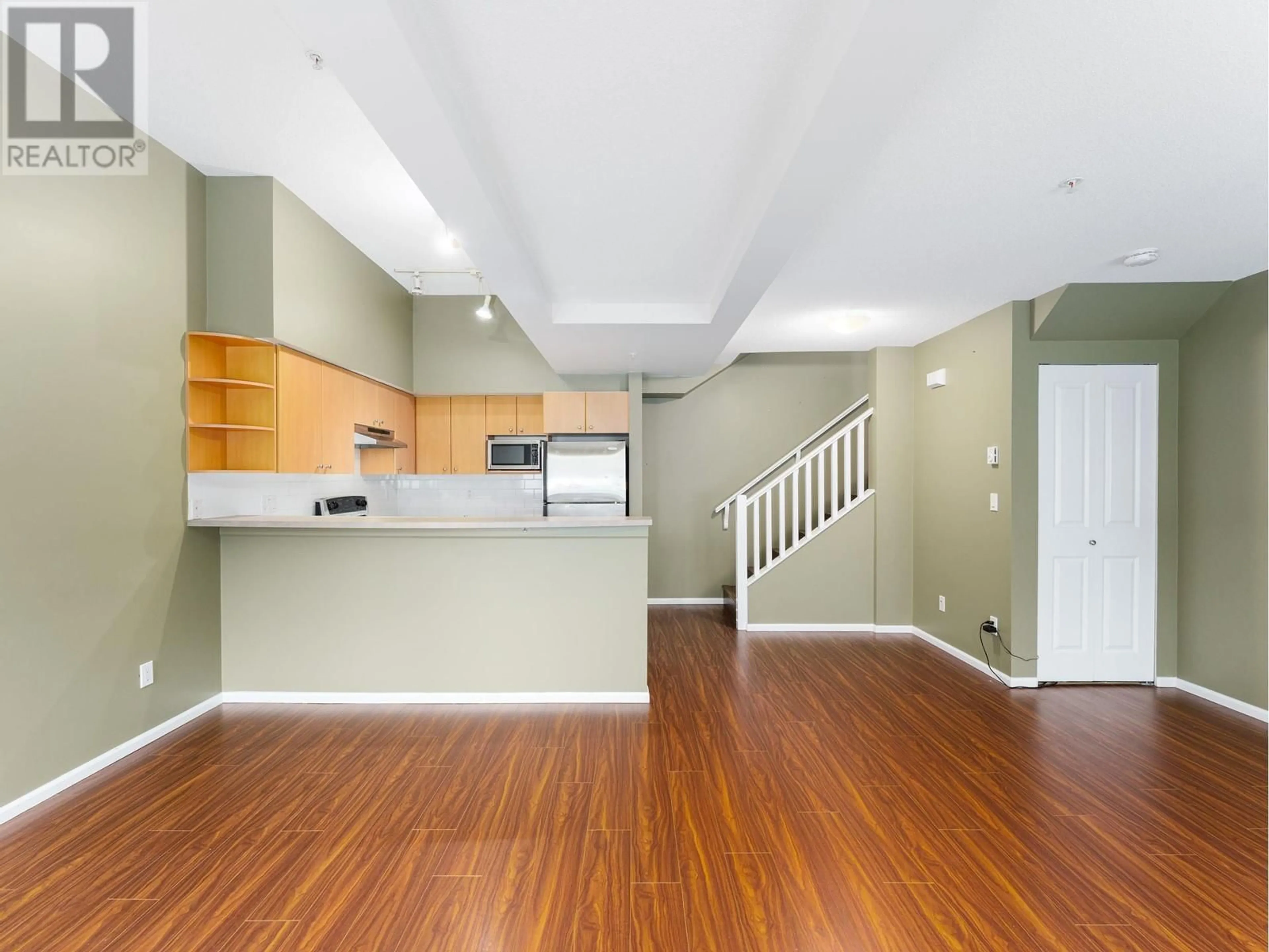 Open concept kitchen, wood/laminate floor for 38 7088 17 AVENUE, Burnaby British Columbia V3N1K5