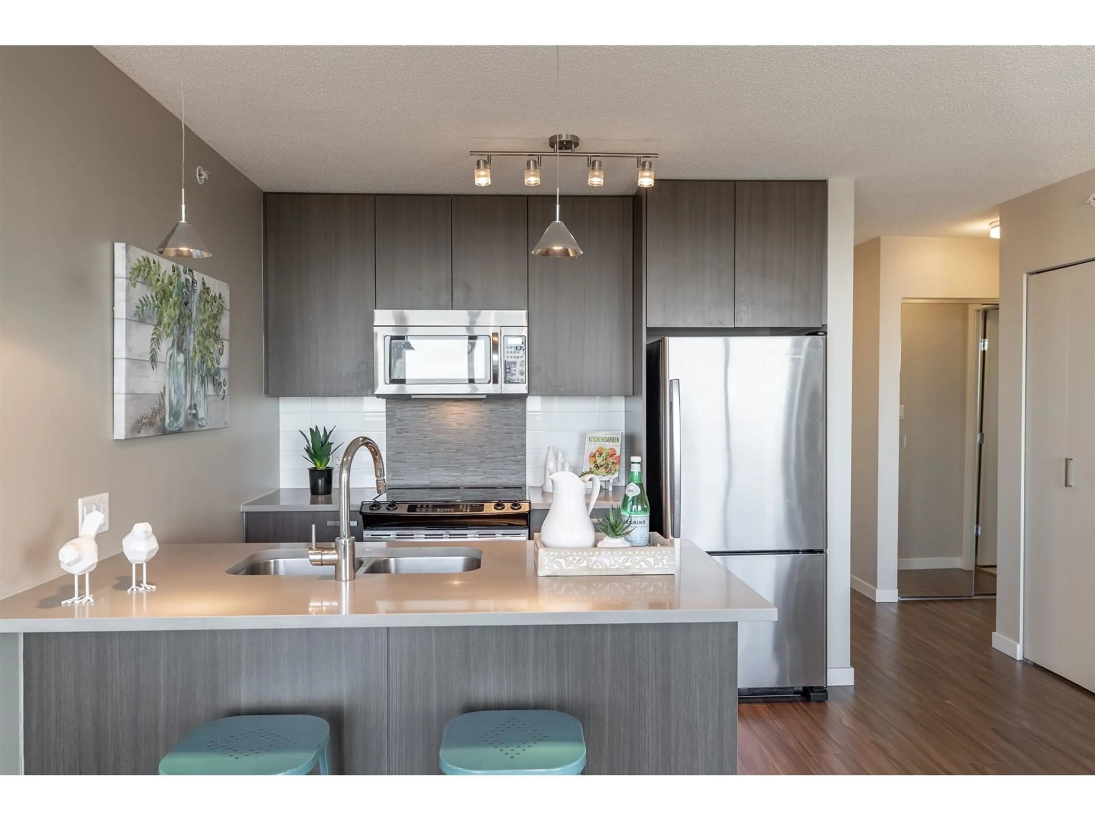 Open concept kitchen, wood/laminate floor for 2215 13325 102A AVENUE, Surrey British Columbia V3T0J5