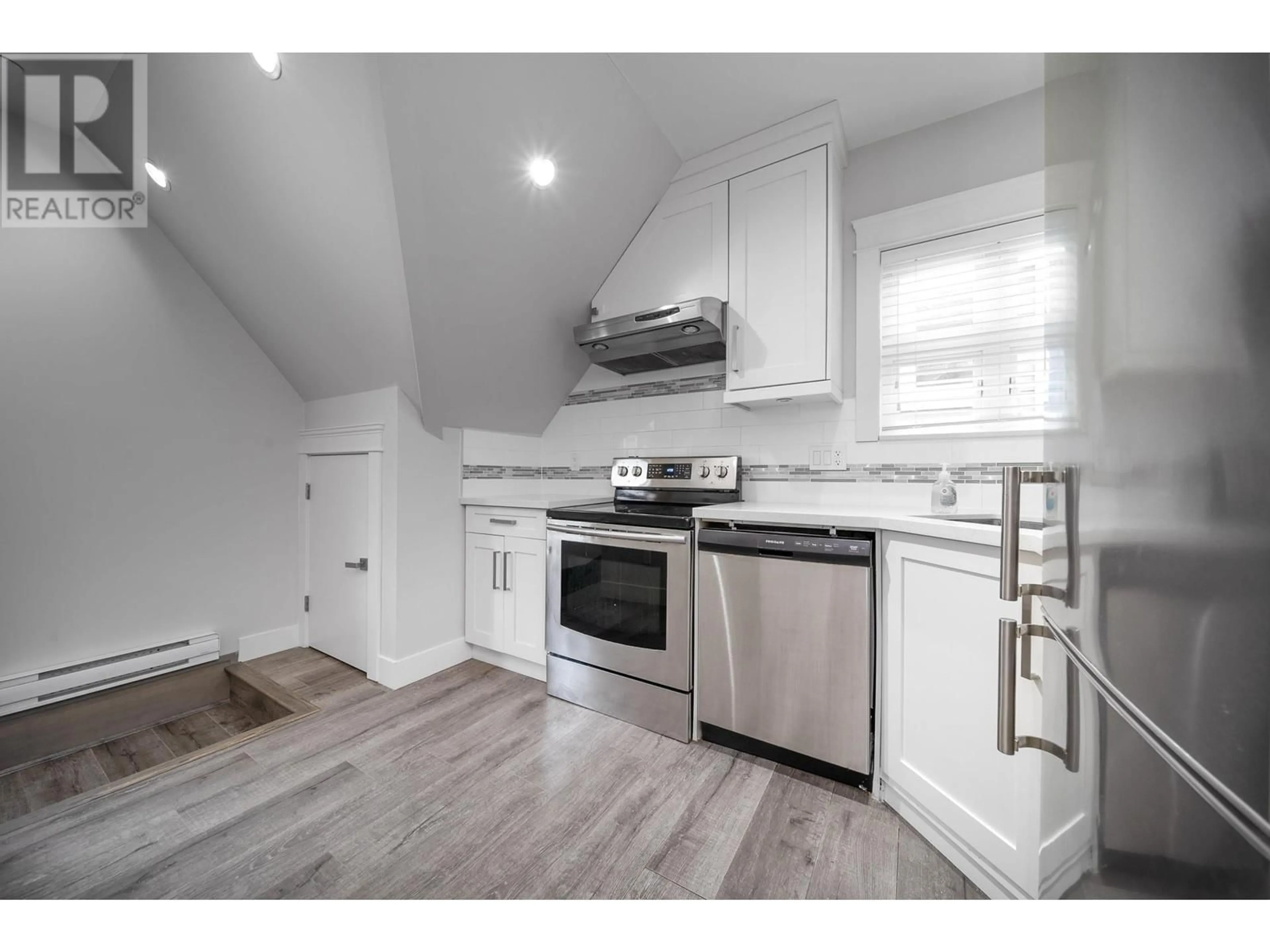 Open concept kitchen, wood/laminate floor for 4513 NANAIMO STREET, Vancouver British Columbia V5N5J2