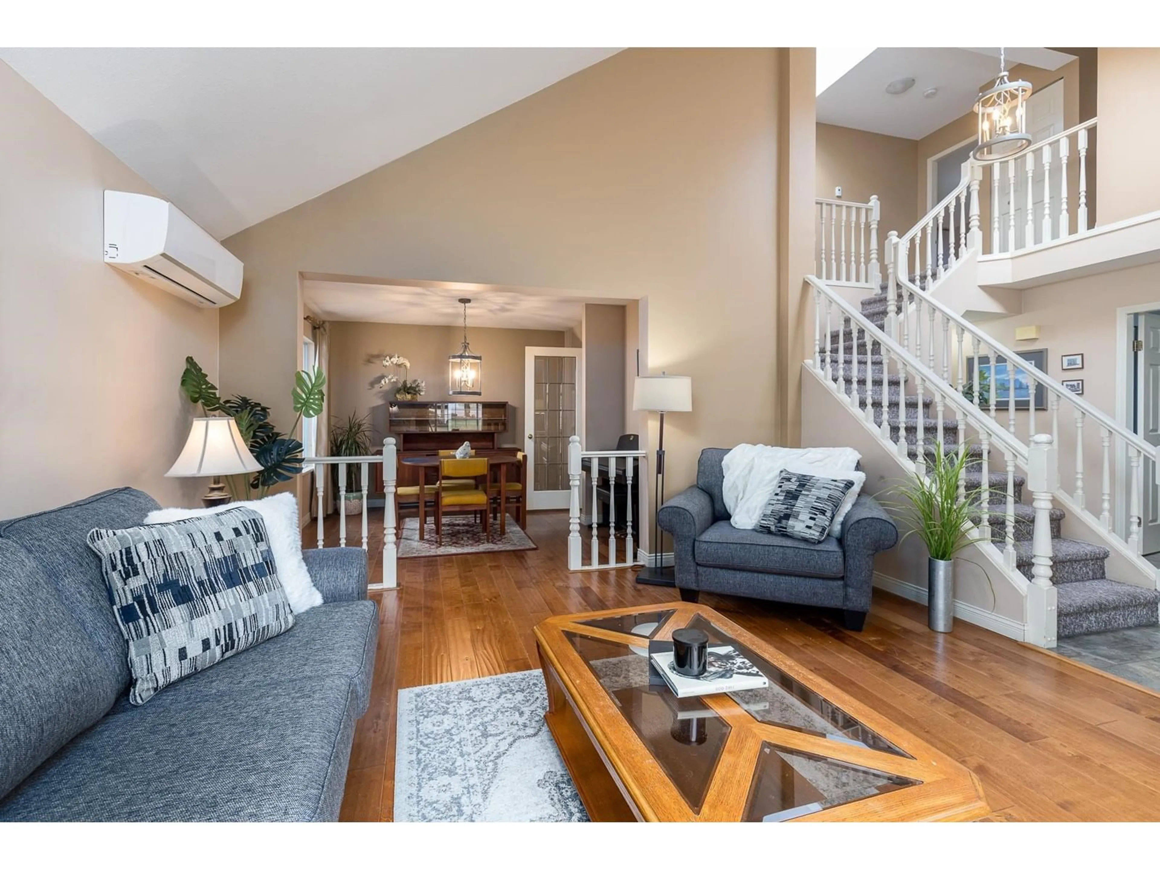 Living room with furniture, wood/laminate floor for 15719 95 AVENUE, Surrey British Columbia V4N3B6