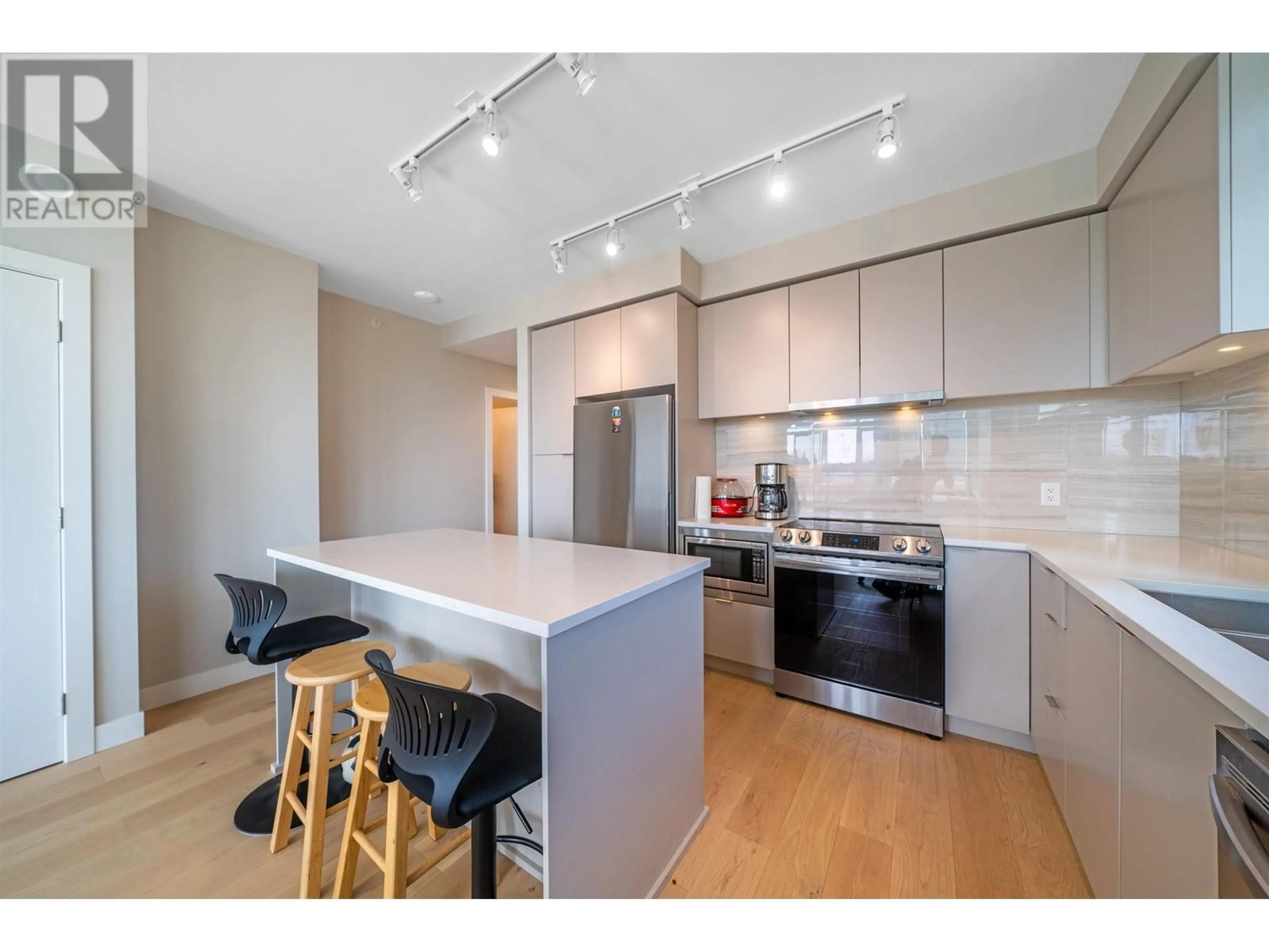 Open concept kitchen, wood/laminate floor for 504 8761 UNIVERSITY CRESCENT, Burnaby British Columbia V5A4Y8