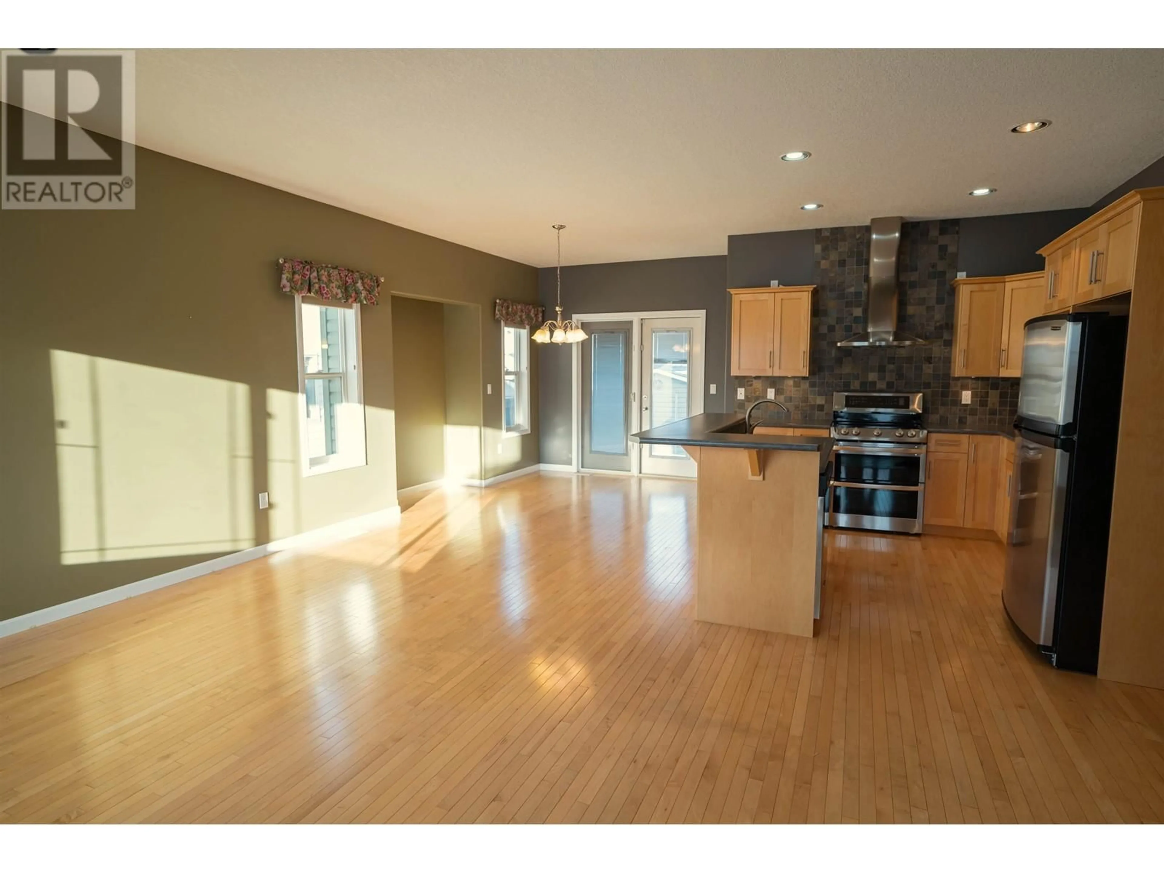 Open concept kitchen, wood/laminate floor for 9612 113 AVENUE, Fort St. John British Columbia V1J2X2