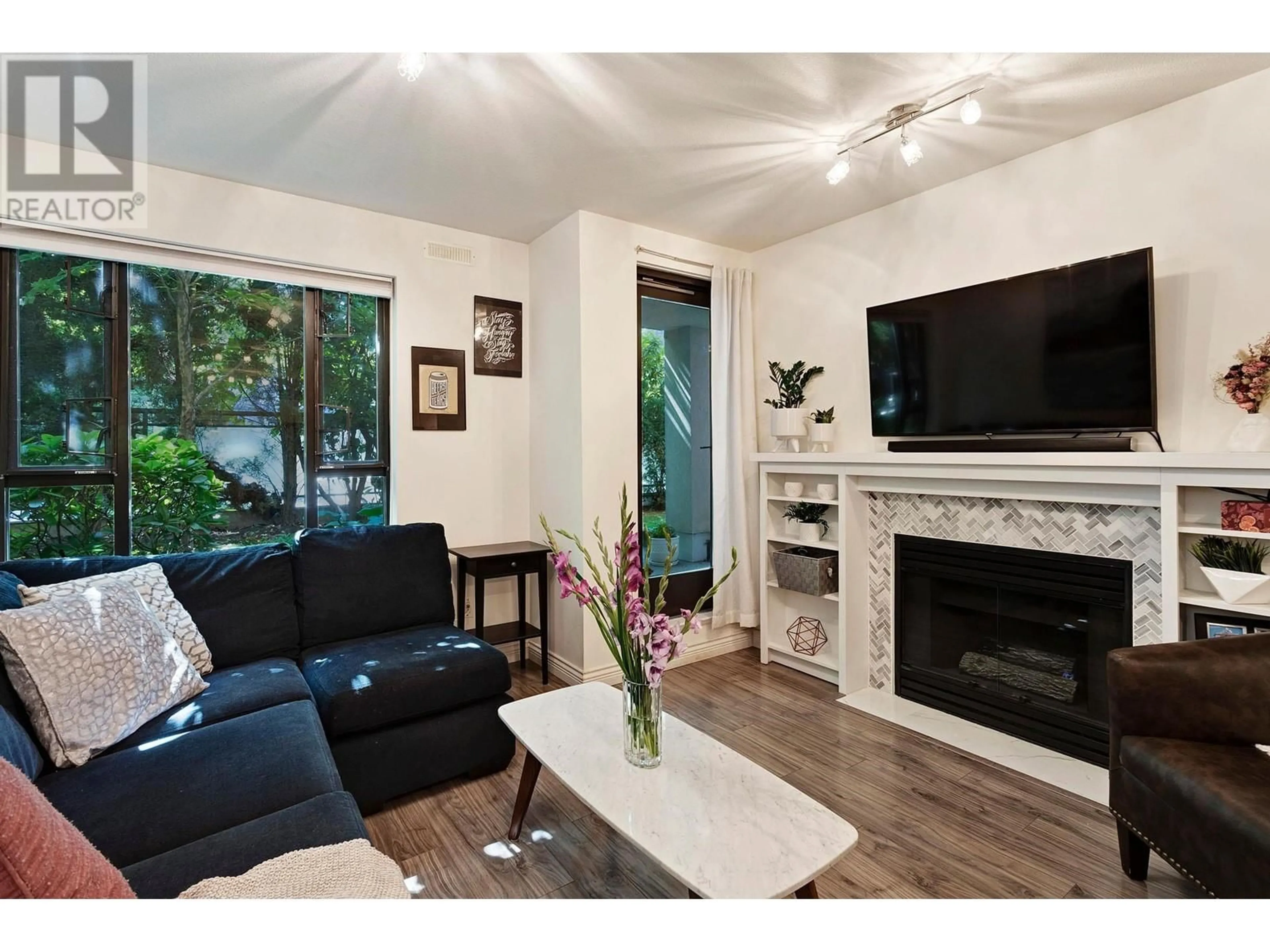 Living room with furniture, wood/laminate floor for 103 175 E 10TH STREET, North Vancouver British Columbia V7L4W1