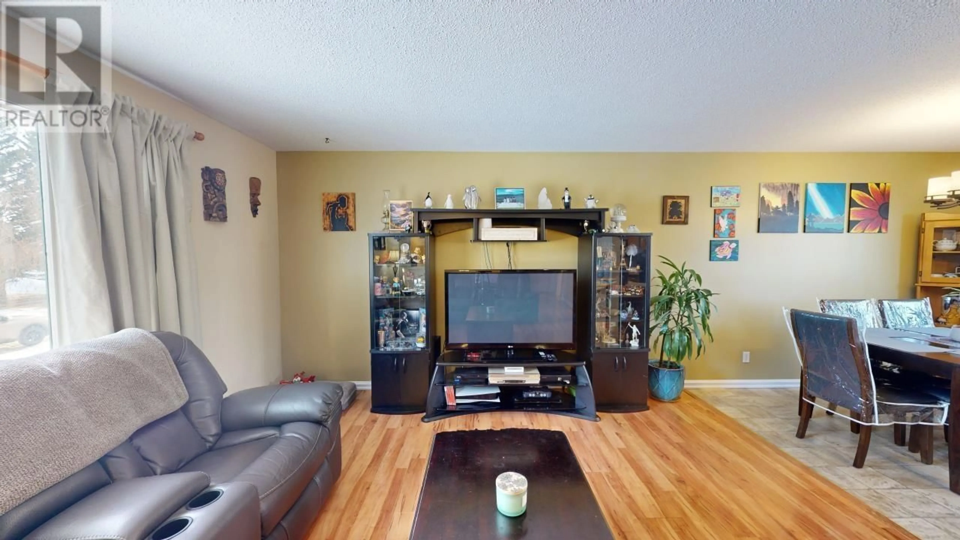 Living room with furniture, wood/laminate floor for 8924 91 STREET, Fort St. John British Columbia V1J4R6