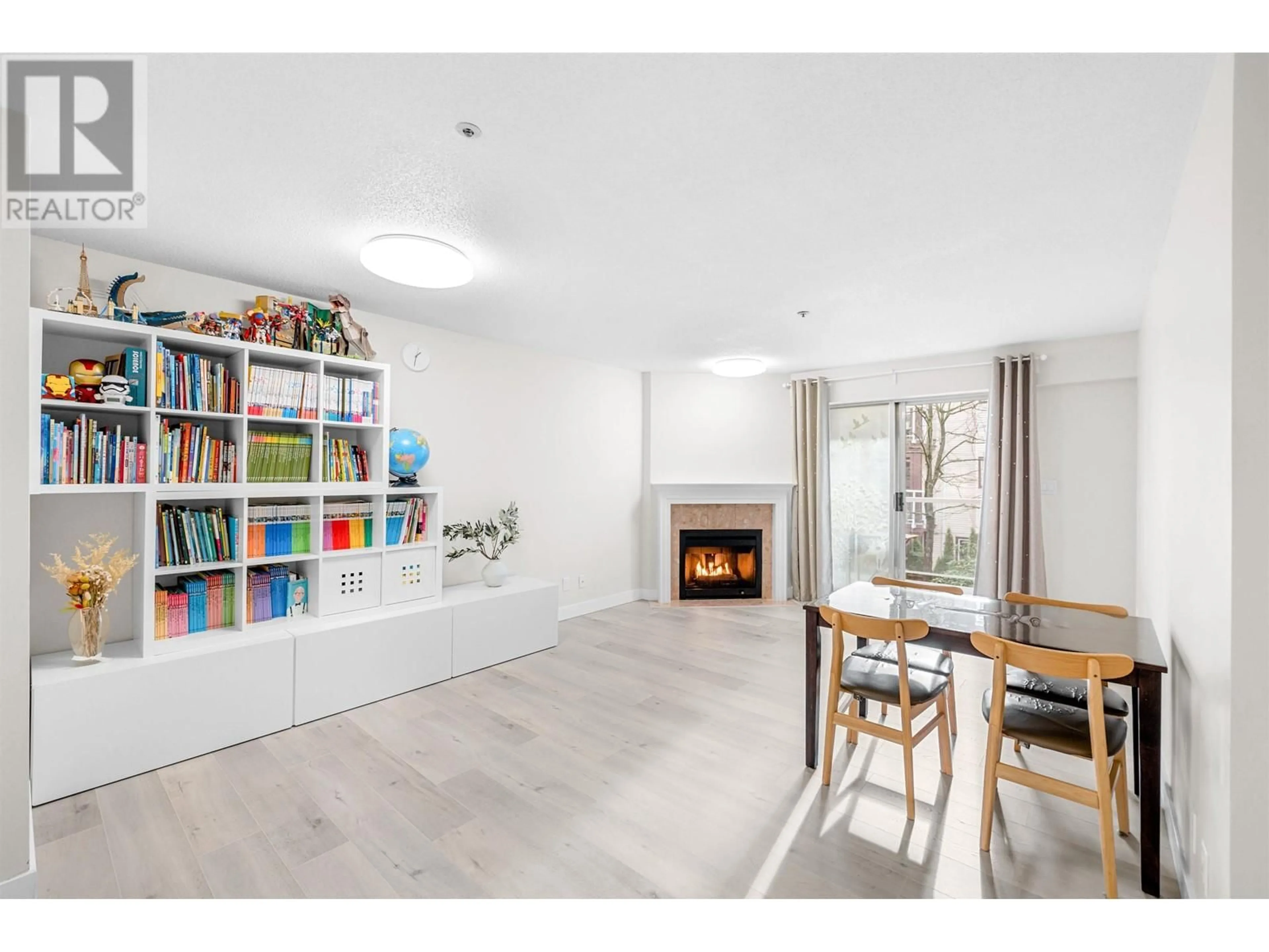 Living room with furniture, wood/laminate floor for 206 3668 RAE AVENUE, Vancouver British Columbia V5R6A7