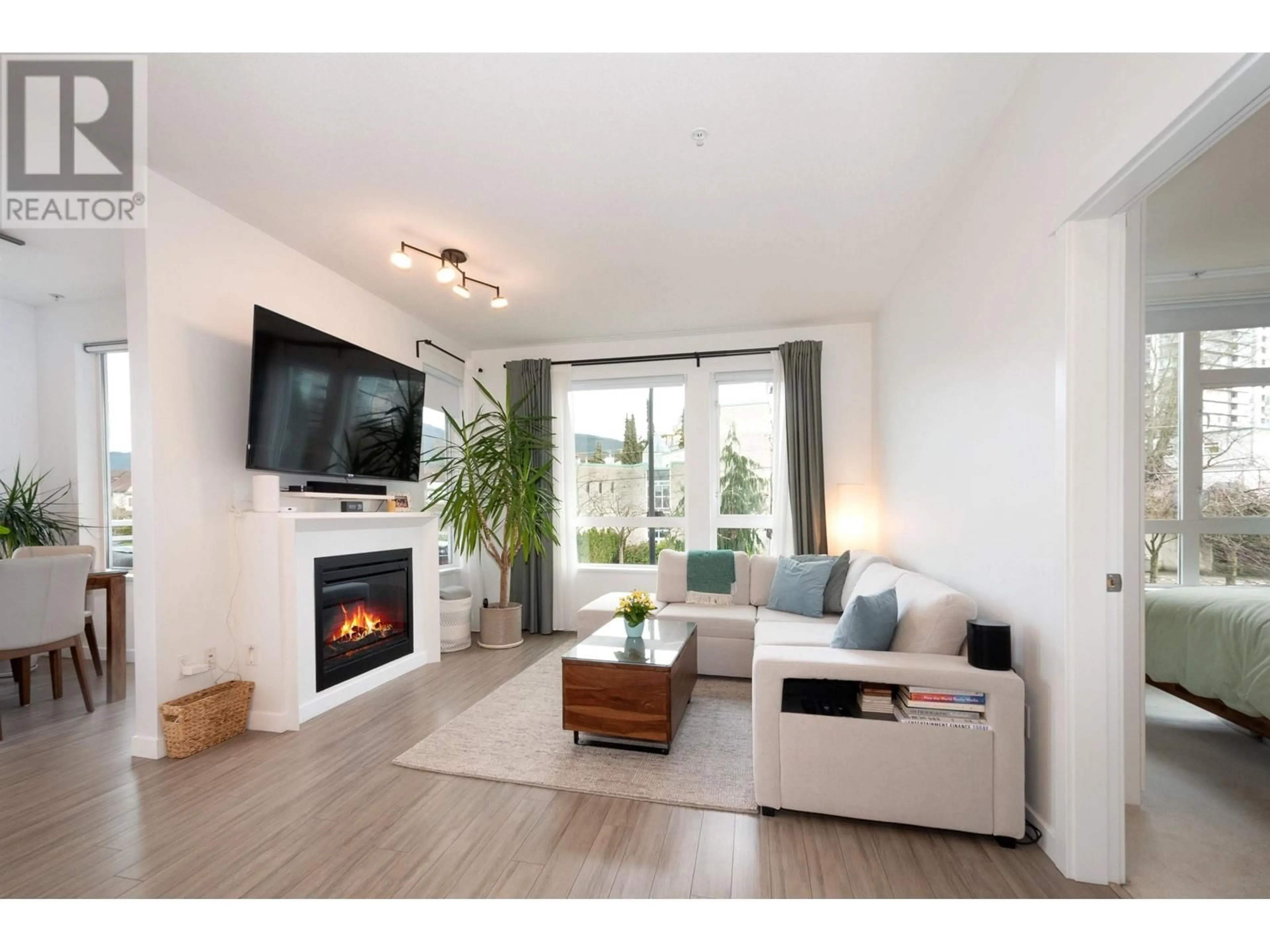 Living room with furniture, wood/laminate floor for 204 217 W 8TH STREET, North Vancouver British Columbia V7M0C2