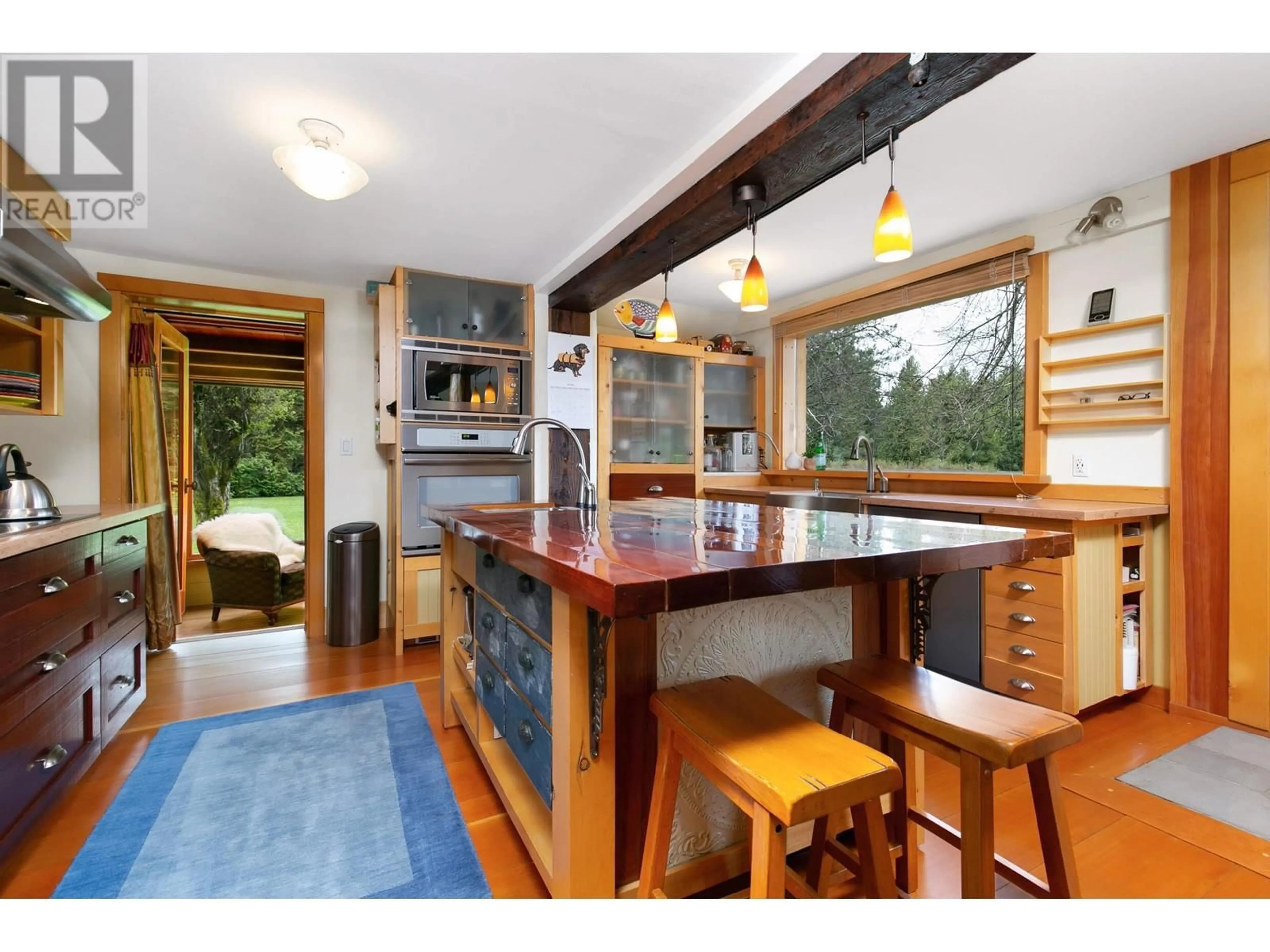 Open concept kitchen, wood/laminate floor for 1865 HIGHWAY 99, Pemberton British Columbia V0N2L1