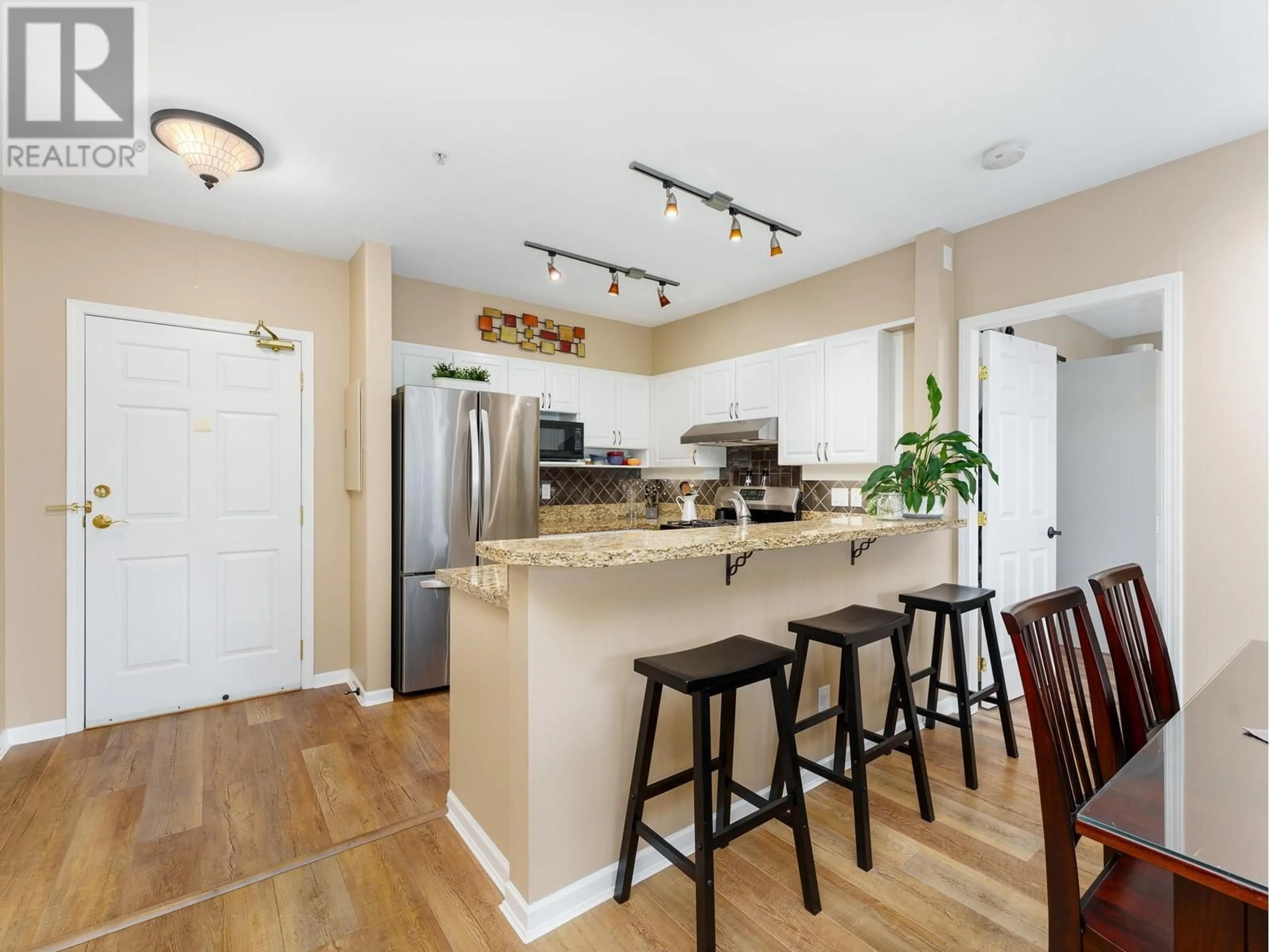 Open concept kitchen, wood/laminate floor for 319 3629 DEERCREST DRIVE, North Vancouver British Columbia V7G2S9