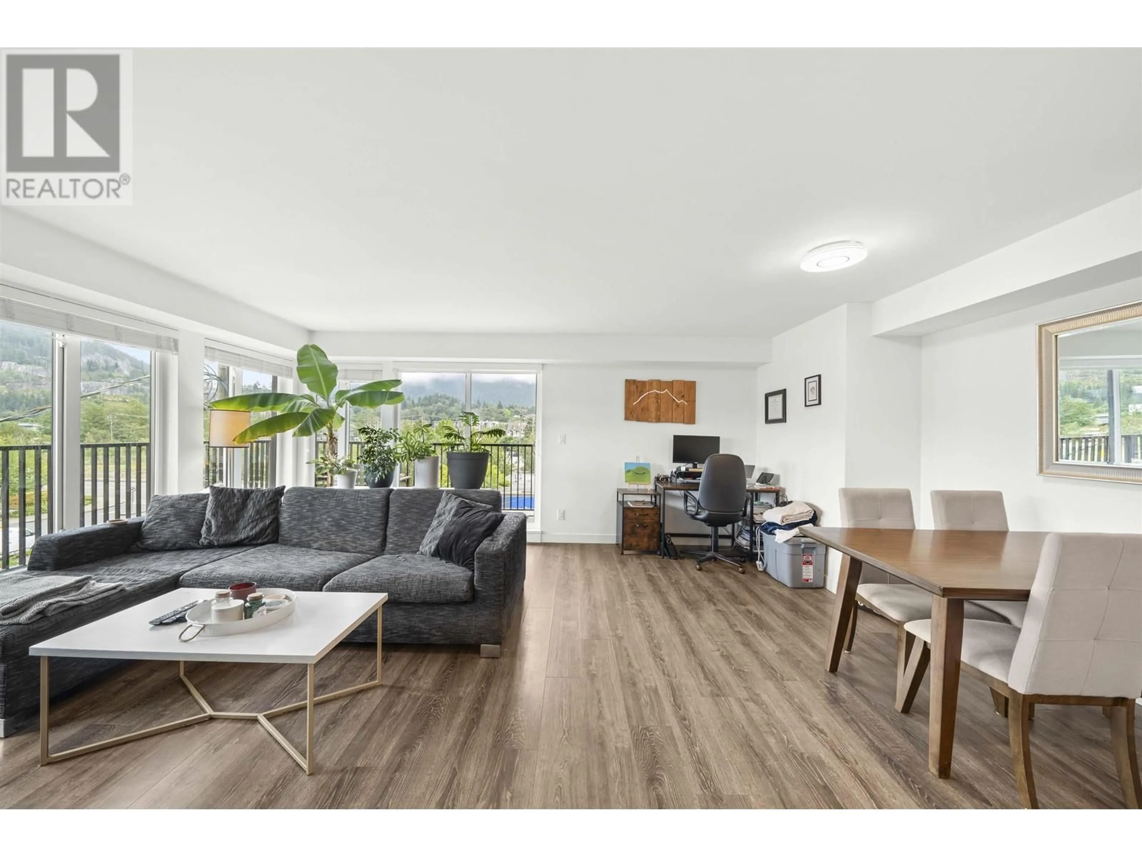 Living room with furniture, wood/laminate floor for 212 1365 PEMBERTON AVENUE, Squamish British Columbia V8B1B7