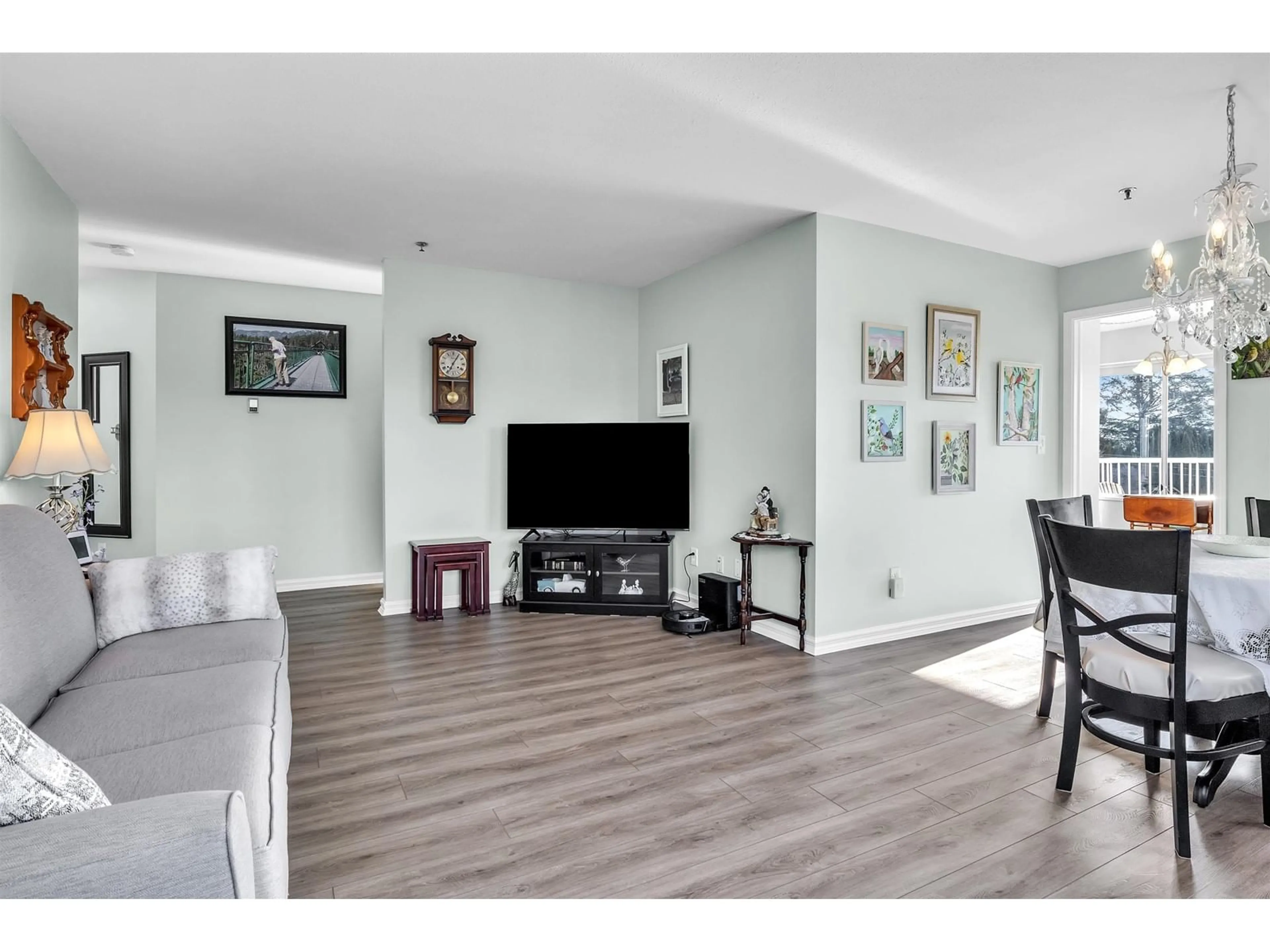 Living room with furniture, wood/laminate floor for 302 33535 KING ROAD, Abbotsford British Columbia V2S6Z5