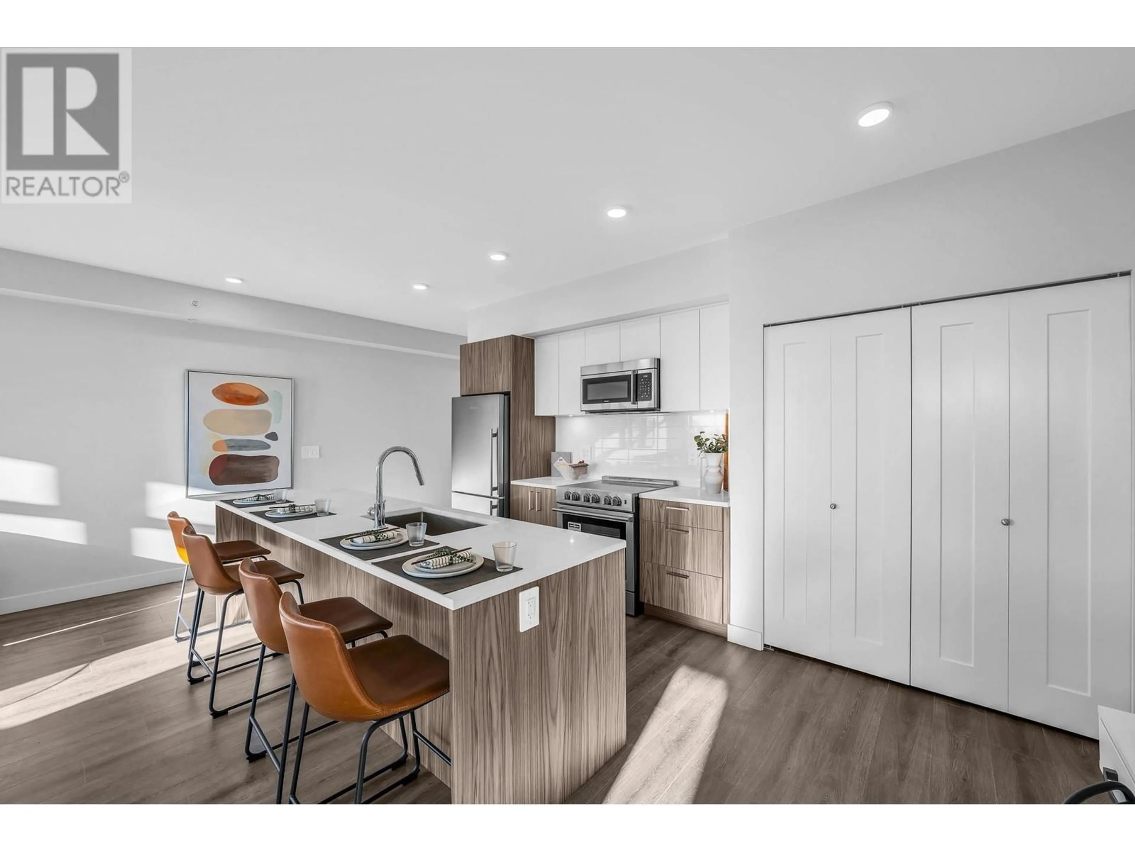 Open concept kitchen, wood/laminate floor for 403 5535 HASTINGS STREET, Burnaby British Columbia V5B1R2