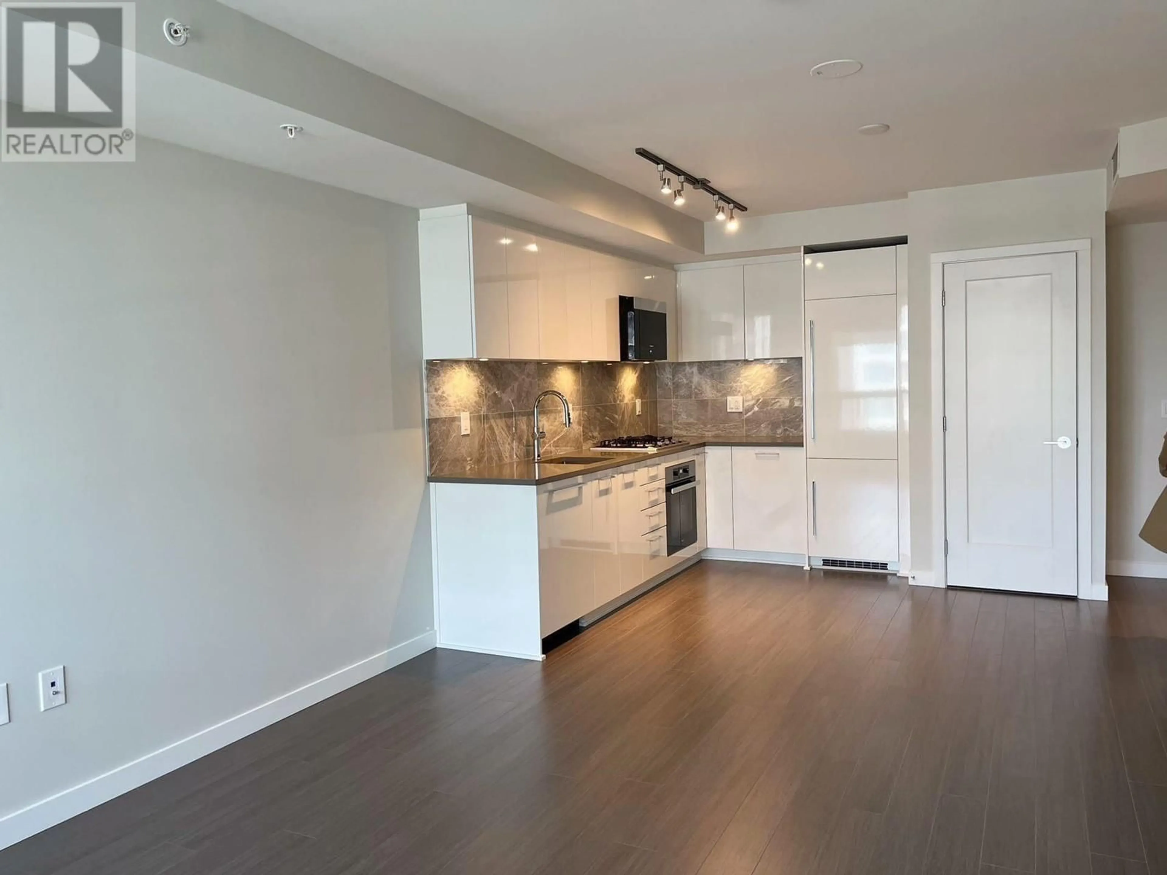 Open concept kitchen, wood/laminate floor for 903 3699 SEXSMITH ROAD, Richmond British Columbia V6X0W4