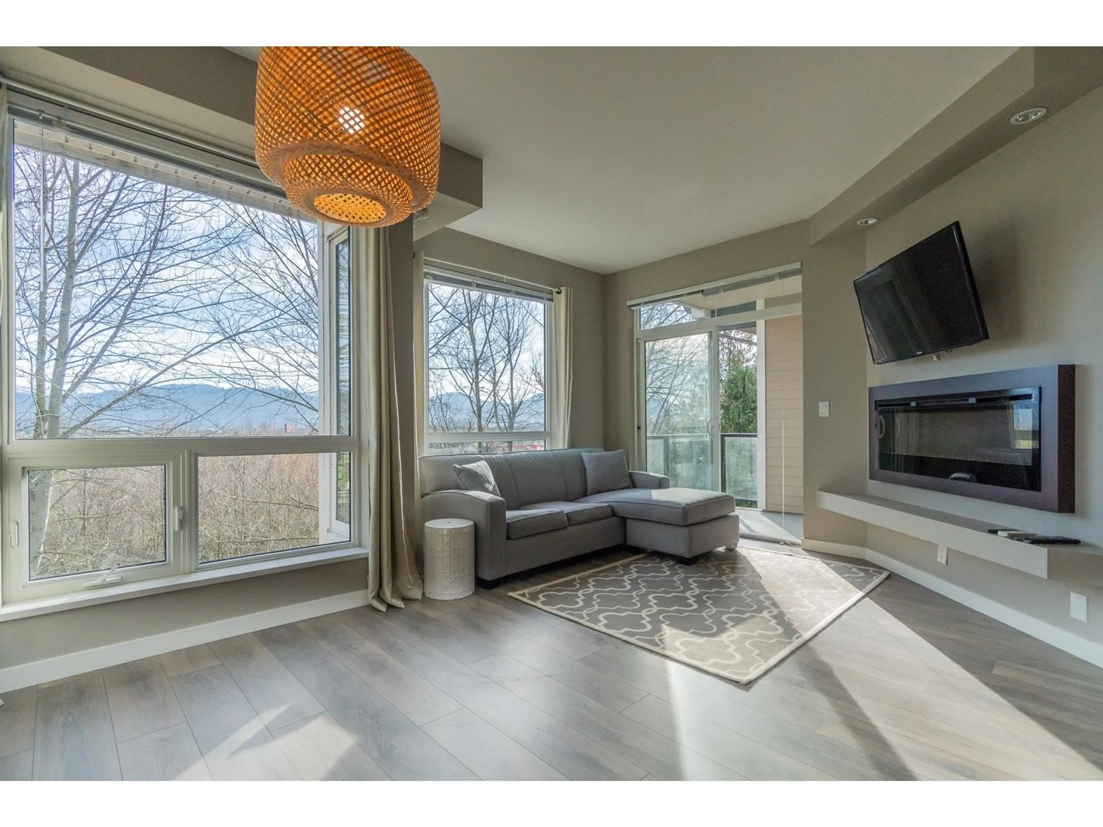 Living room with furniture, wood/laminate floor for 415 2238 WHATCOM ROAD, Abbotsford British Columbia V3G0E6